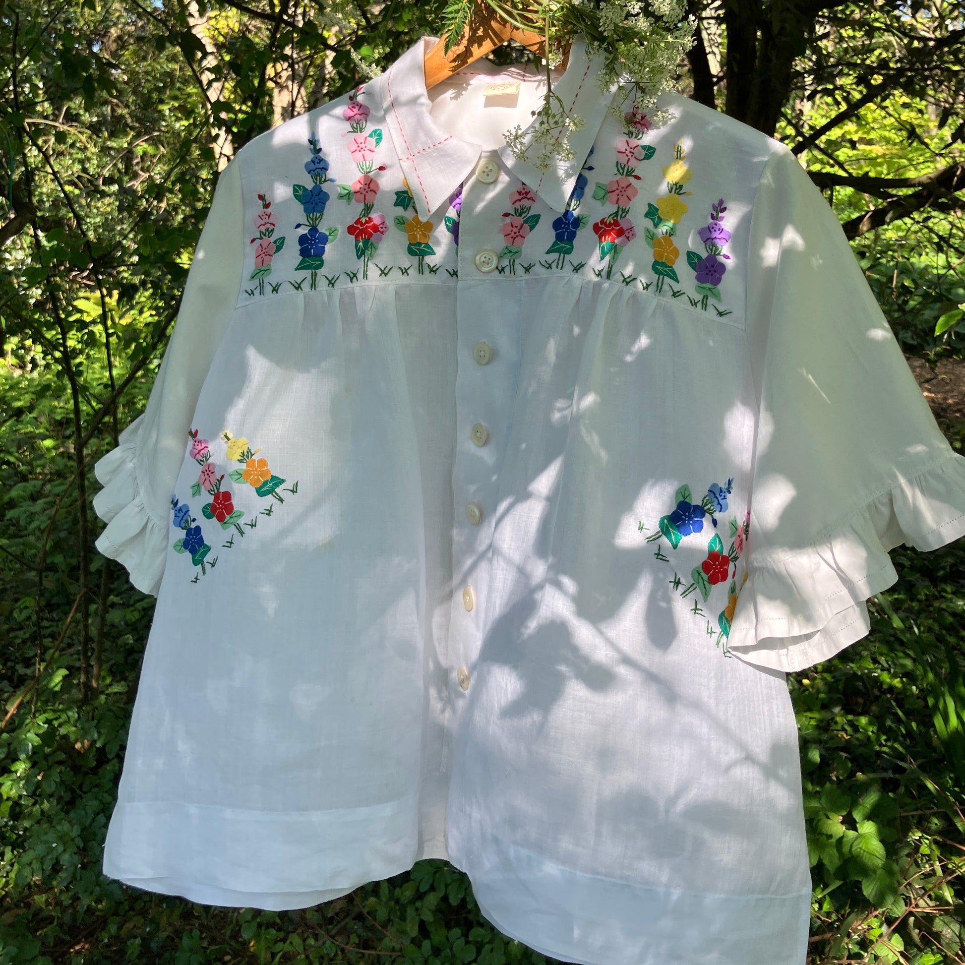Blouse with ruffle sleeves made from a reclaimed linen tablecloth with floral applique