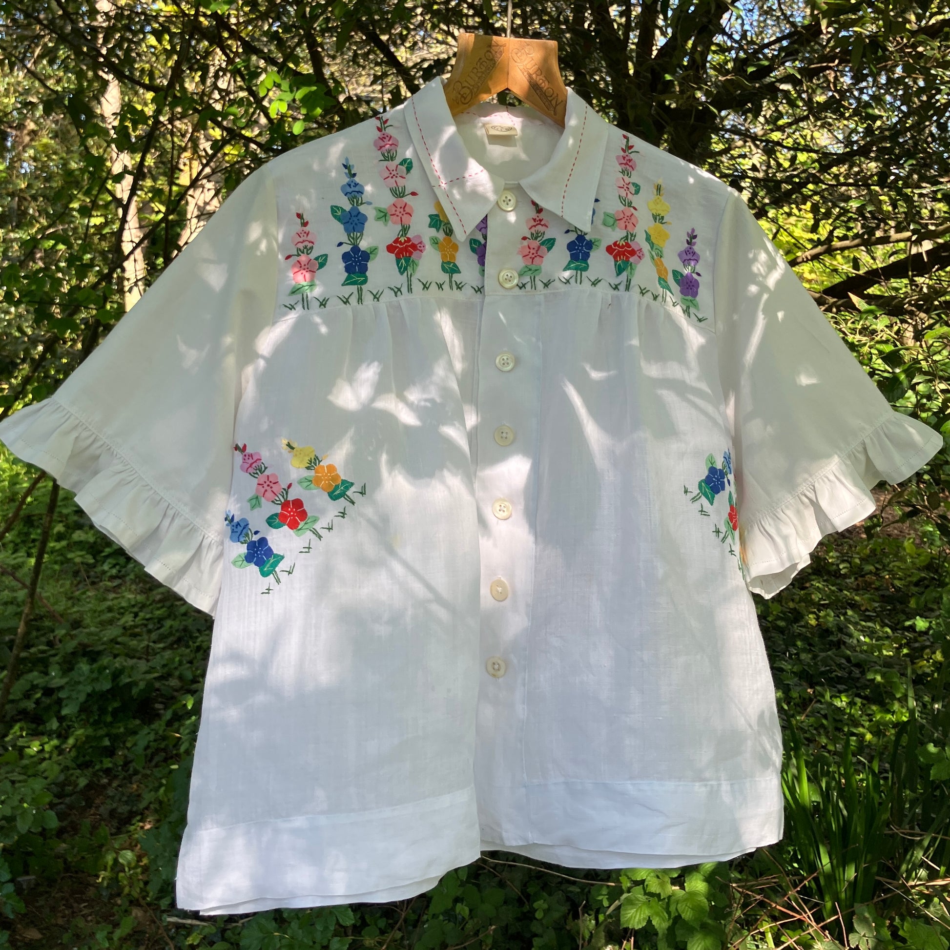 Blouse with ruffle sleeves made from a reclaimed linen tablecloth with floral applique