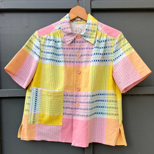 Shirt made from a reclaimed cotton tablecloth in pastel shades of pink, blue, peach and bright yellow