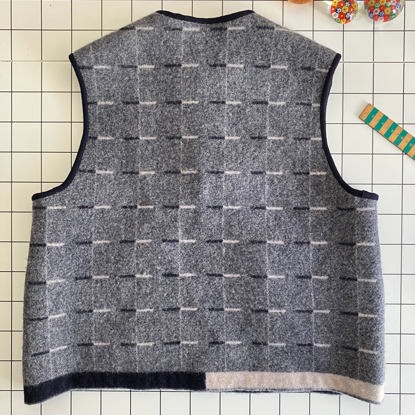 Cosy vest made from a reclaimed grey and blue lambswool blanket with two tie fastenings