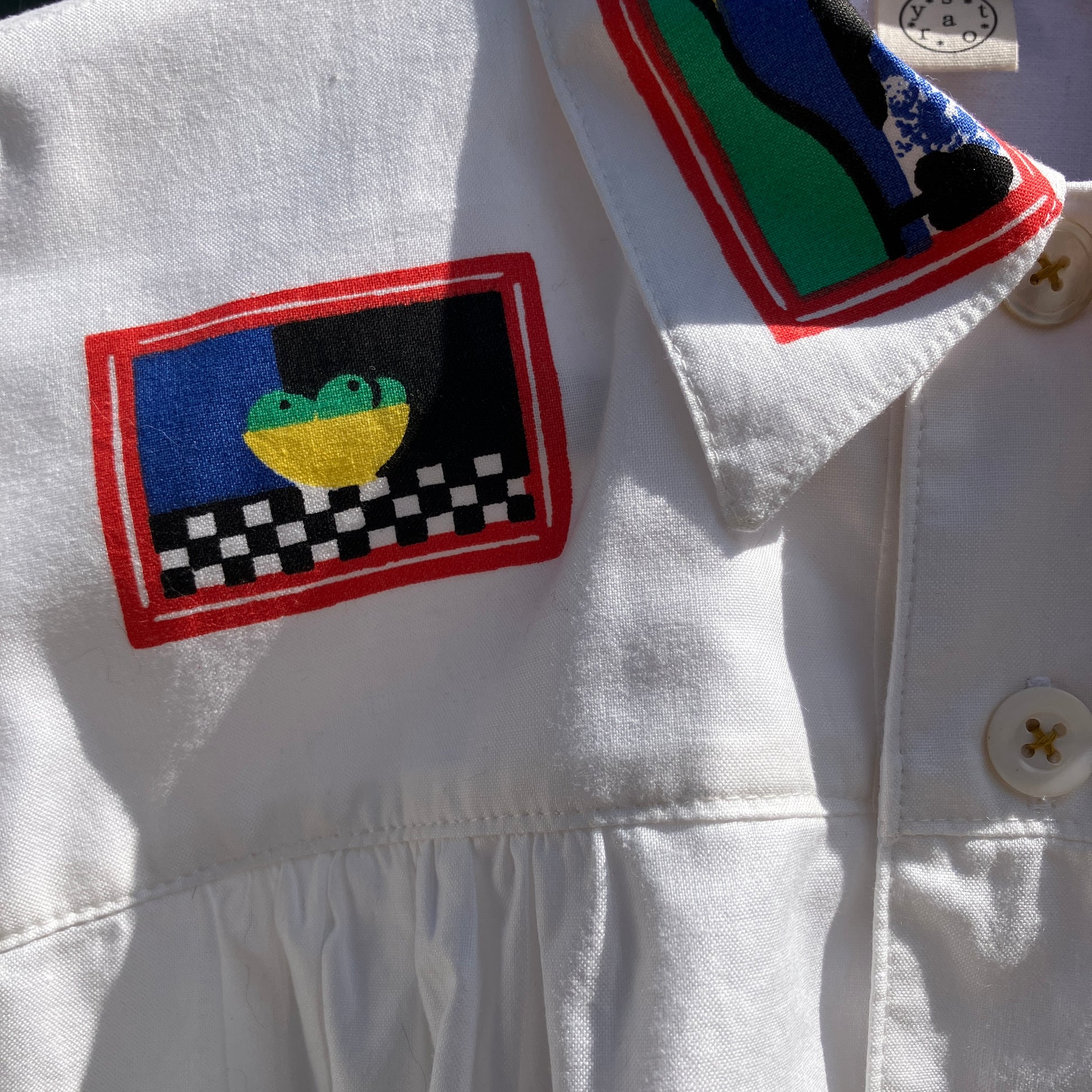 shirt made from 80s deadstock fabric with a print of tiny paintings in frames