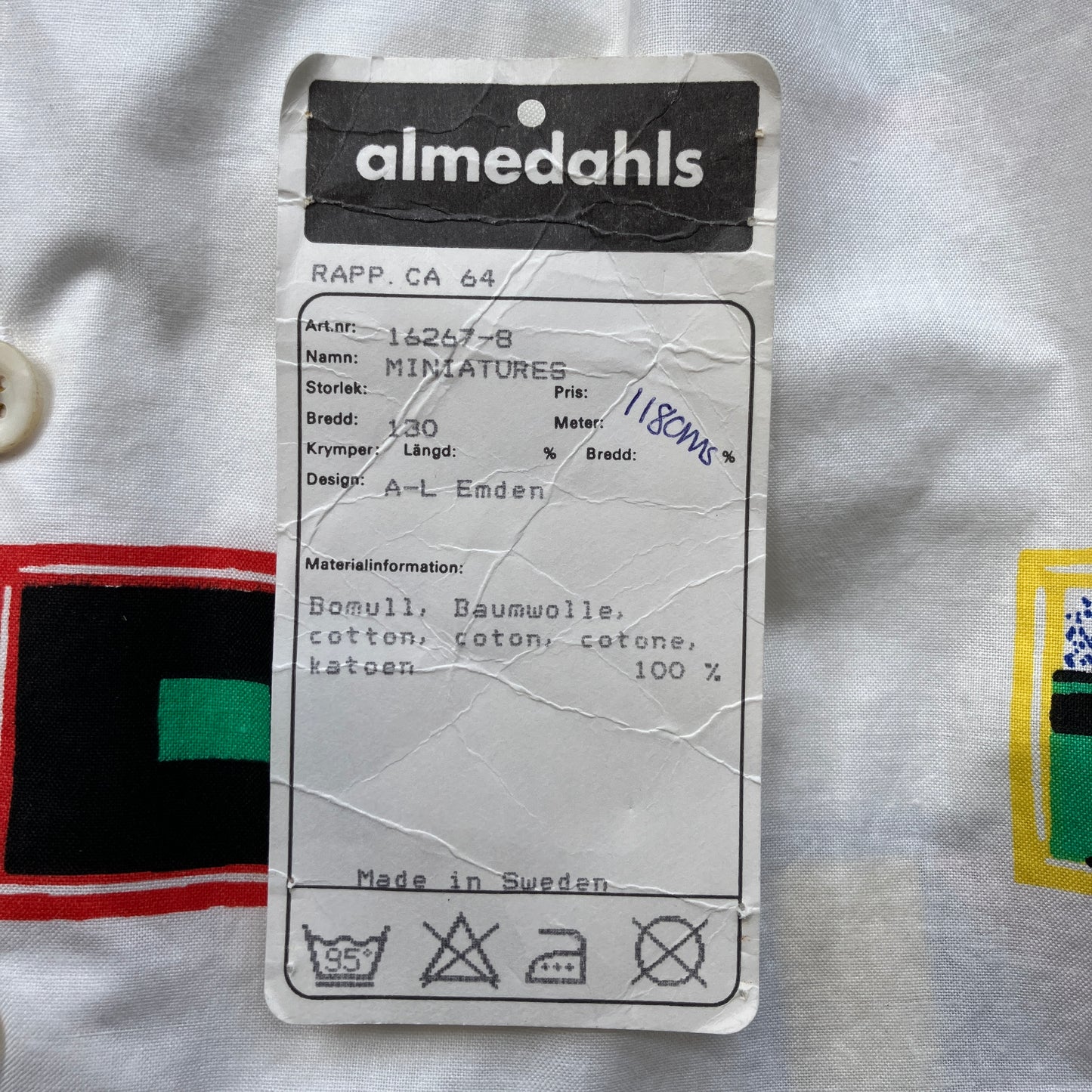 Deadstock fabric label with 'almedahls' brand used to make a shirt with a print of tiny paintings in frames