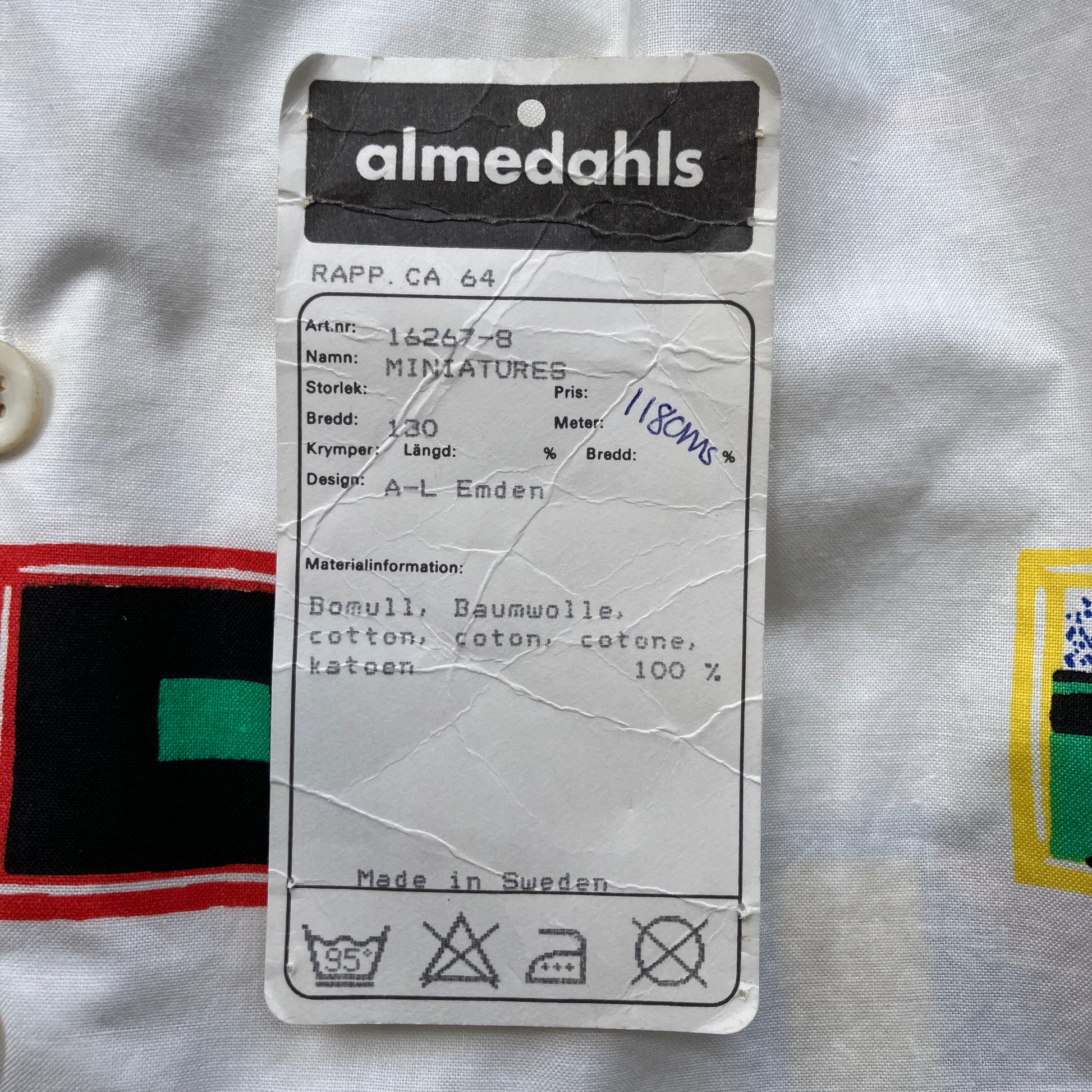 Deadstock fabric label with 'almedahls' brand used to make a shirt with a print of tiny paintings in frames