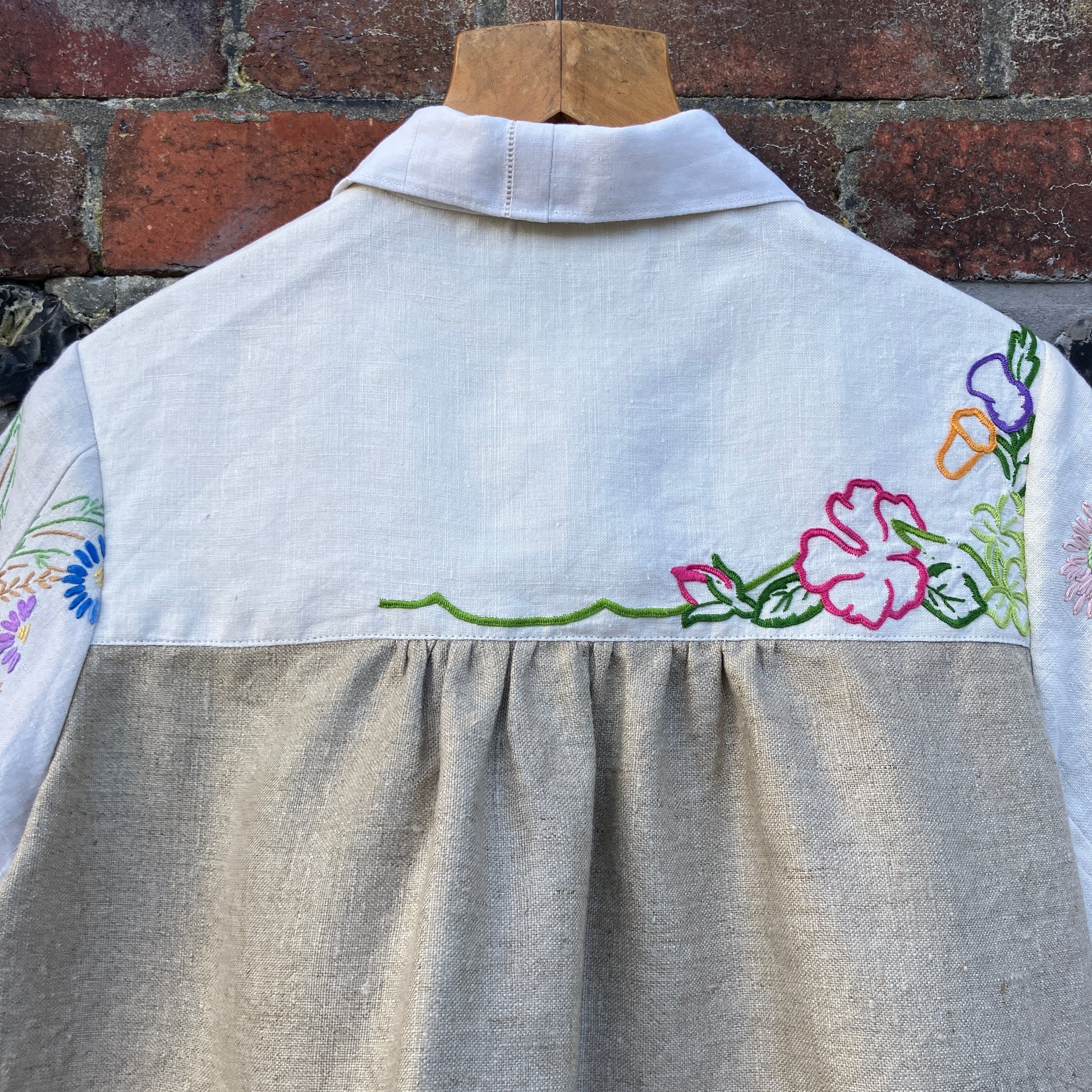 Shirt made from a patchwork of part-finished hand embroidered linen panels in various shades of off-white and natural.