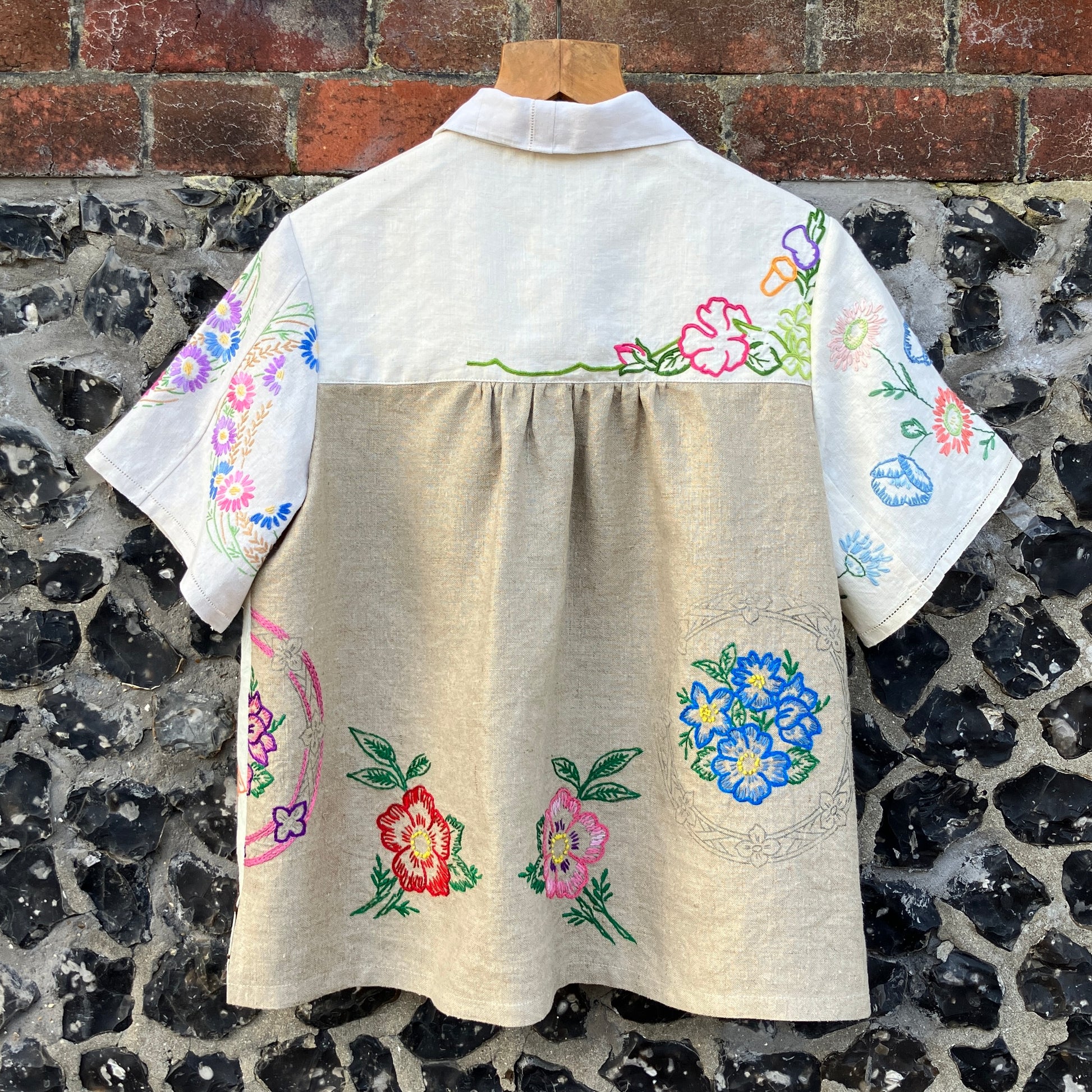 Shirt made from a patchwork of part-finished hand embroidered linen panels in various shades of off-white and natural.