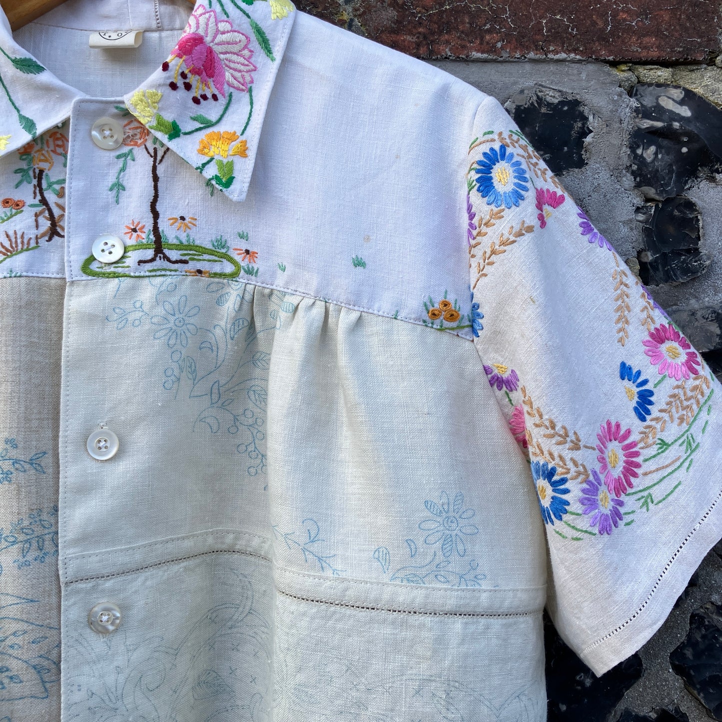 Shirt made from a patchwork of part-finished hand embroidered linen panels in various shades of off-white and natural.