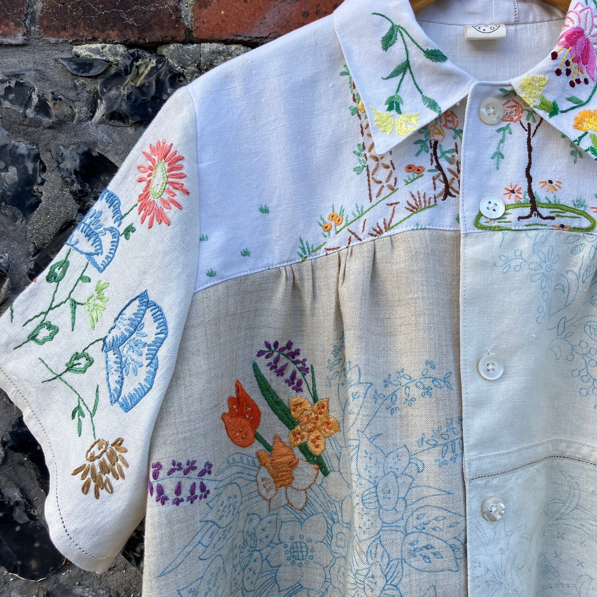 Shirt made from a patchwork of part-finished hand embroidered linen panels in various shades of off-white and natural.