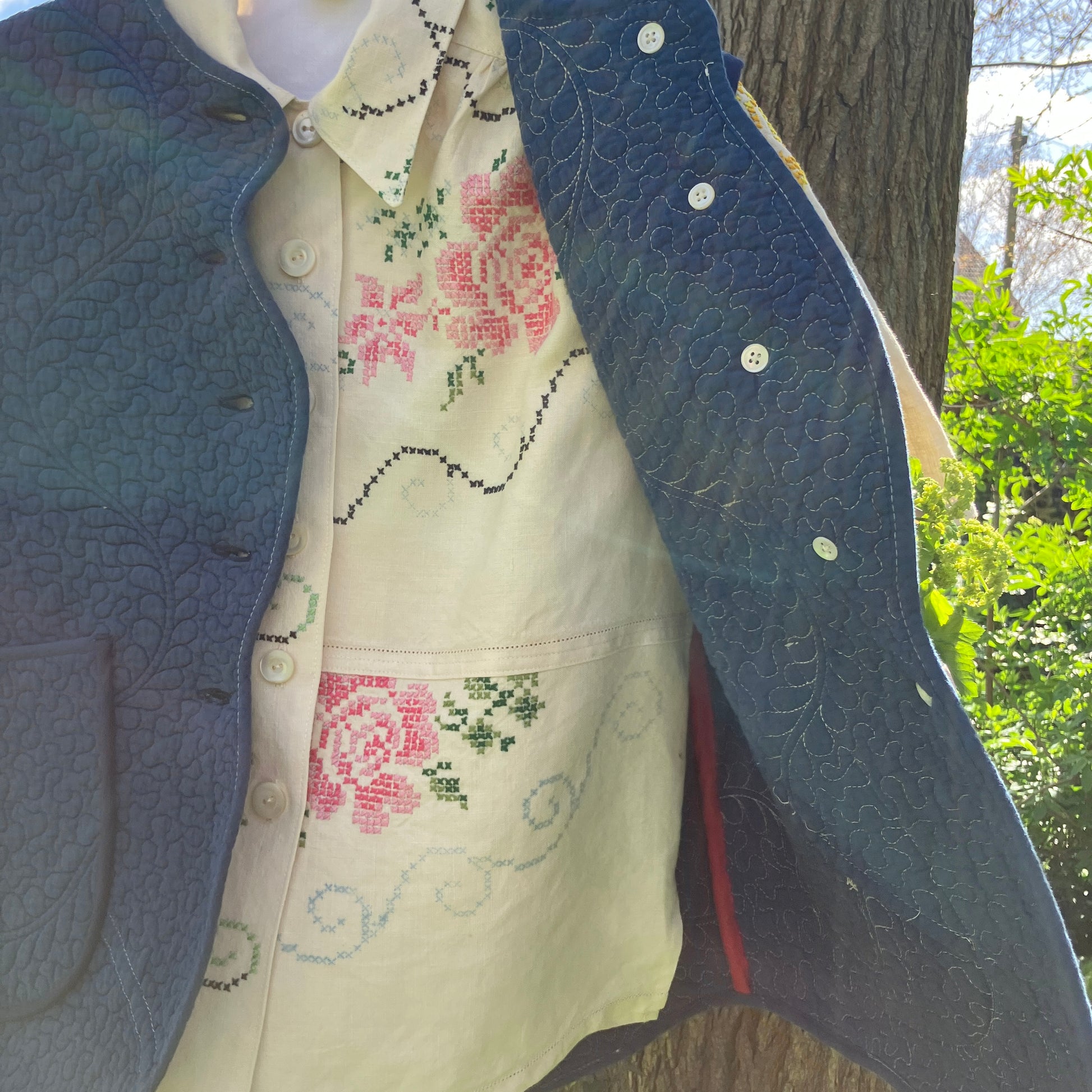 Blouse made from recycled cross stitch linen tablecloth worn with vintage quilt vest