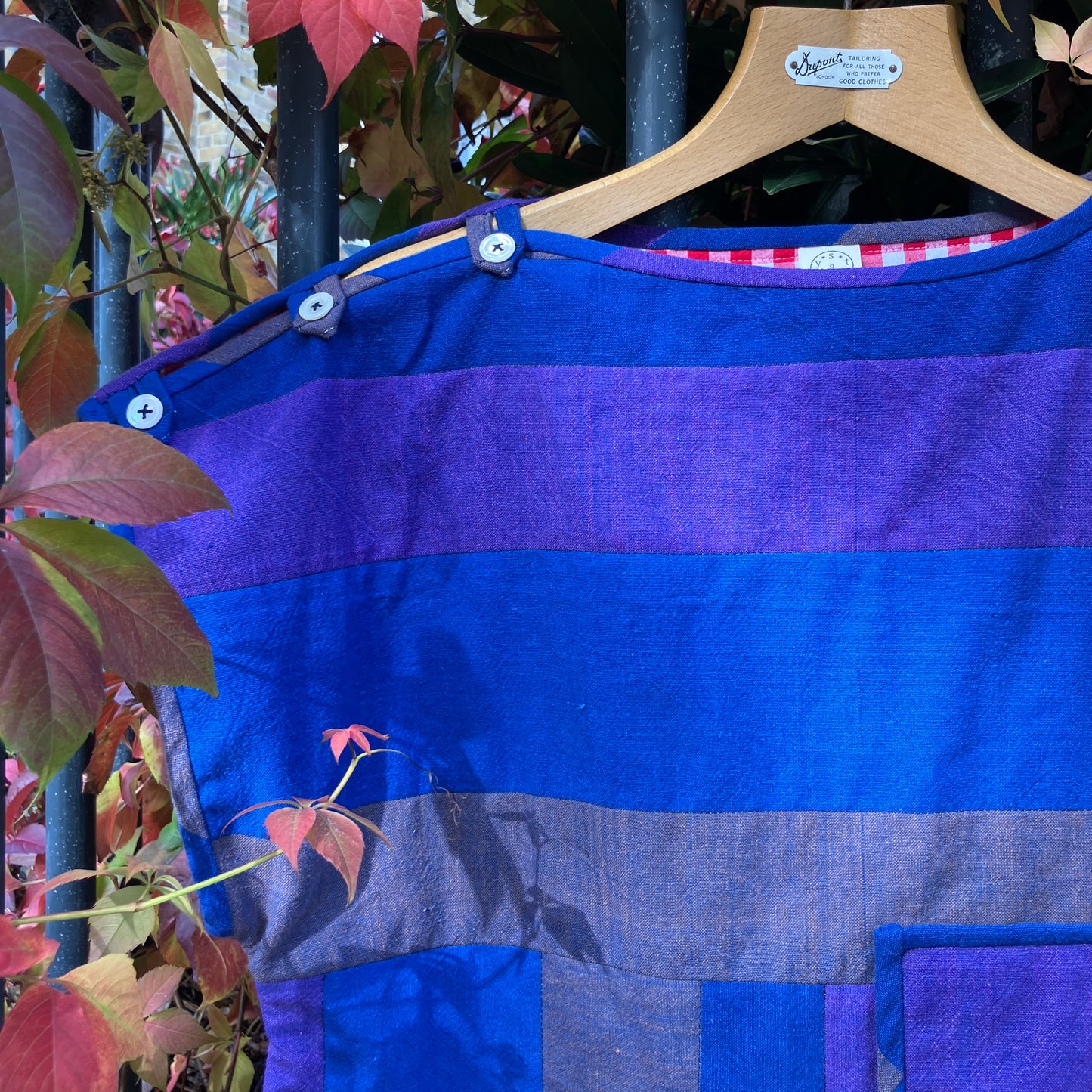 Blue and purple striped quilted top made from recycled fabrics, with a zip-up pocket