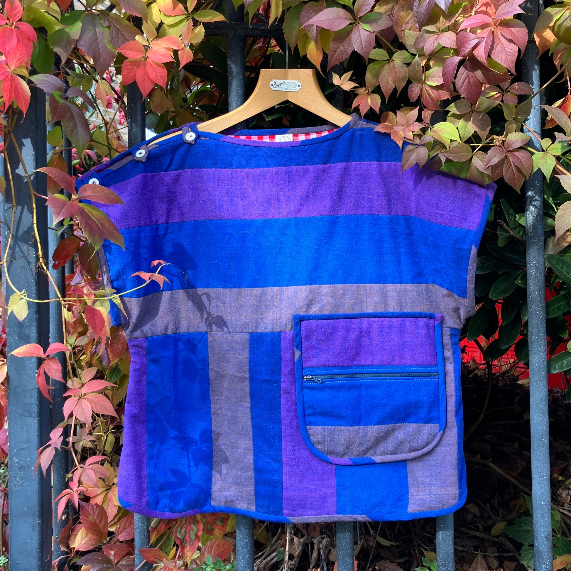 Blue and purple striped quilted top made from recycled fabrics, with a zip-up pocket