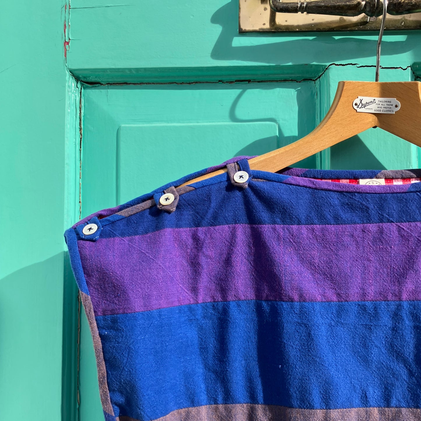Blue and purple striped quilted top made from recycled fabrics, with a zip-up pocket