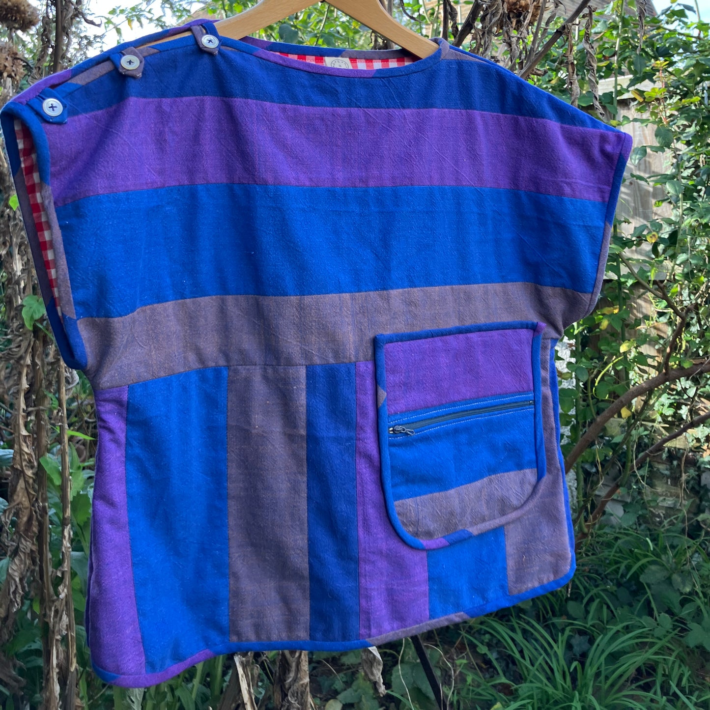 Blue and purple striped quilted top made from recycled fabrics, with a zip-up pocket