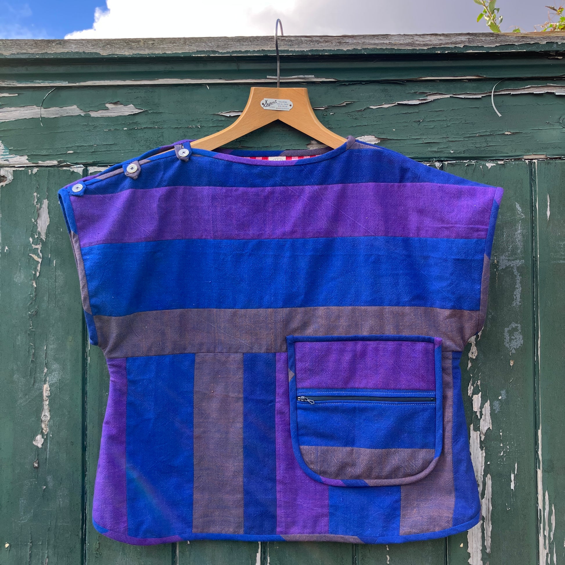 Blue and purple striped quilted top made from recycled fabrics, with a zip-up pocket