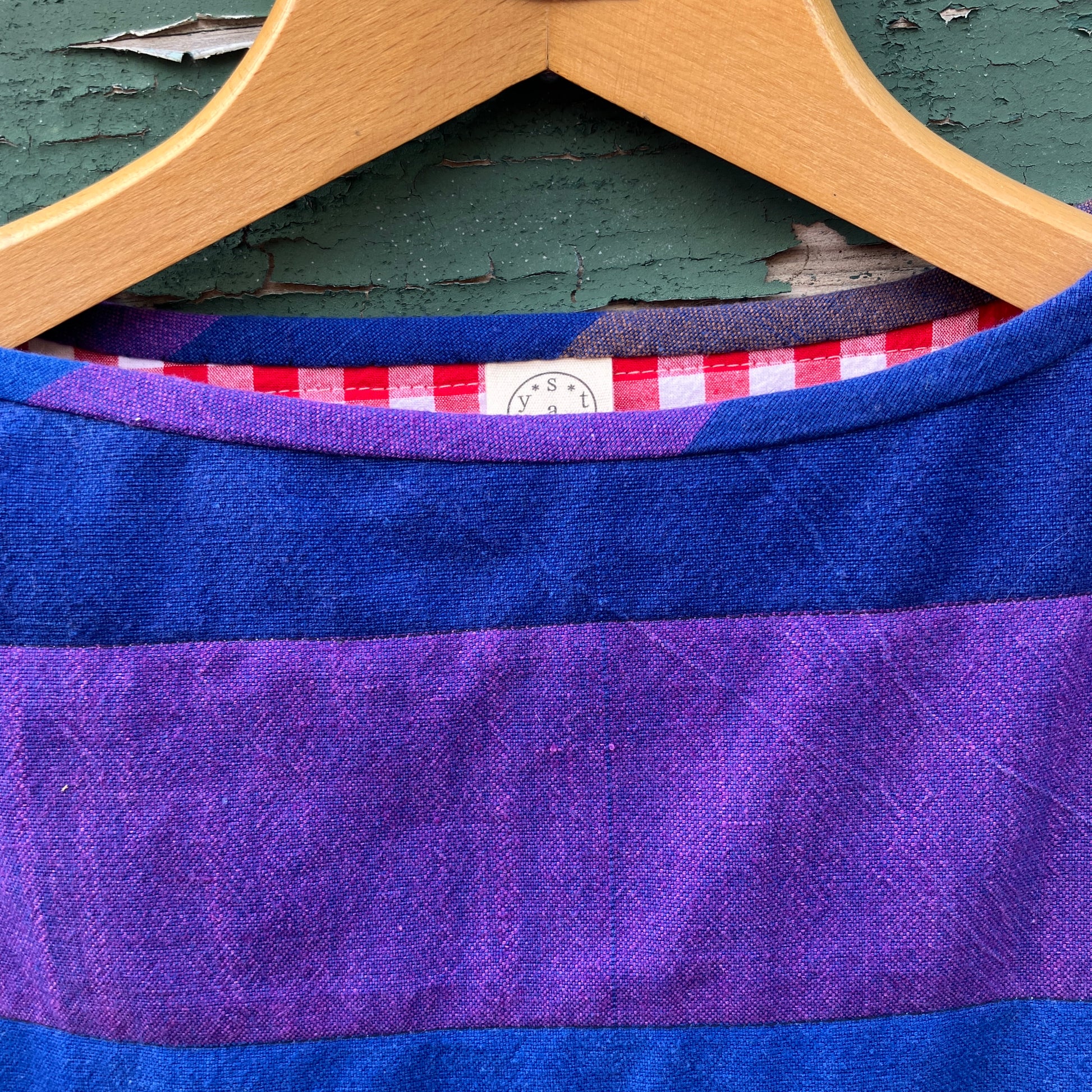Blue and purple striped quilted top made from recycled fabrics, with a zip-up pocket