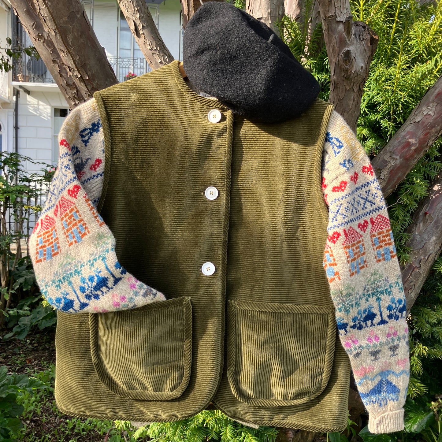 Reclaimed olive green corduroy vest with the wales going in a horizontal direction. Lined with dusky pink (possibly avocado dyed) cotton