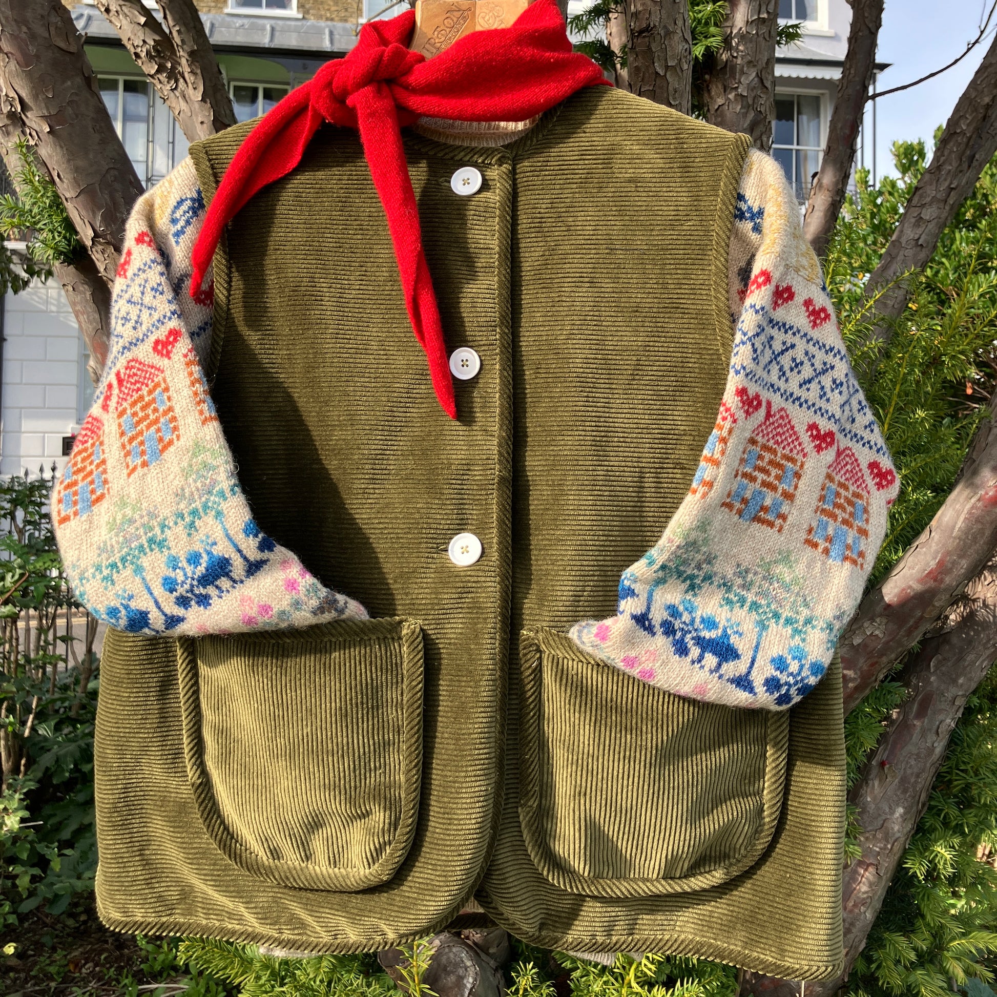 Reclaimed olive green corduroy vest with the wales going in a horizontal direction. Lined with dusky pink (possibly avocado dyed) cotton