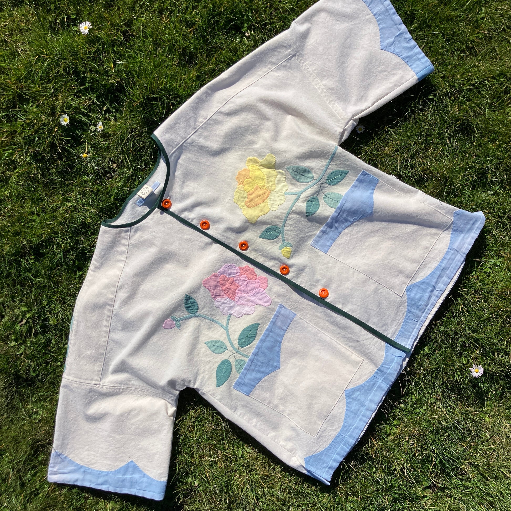 Pretty boxy top with pastel-coloured floral appliqué, made from a vintage cotton bedspread with scalloped edges