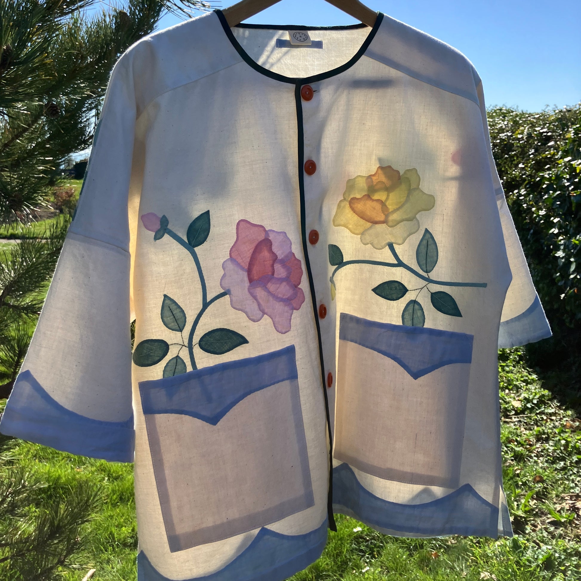 Pretty boxy top with pastel-coloured floral appliqué, made from a vintage cotton bedspread with scalloped edges
