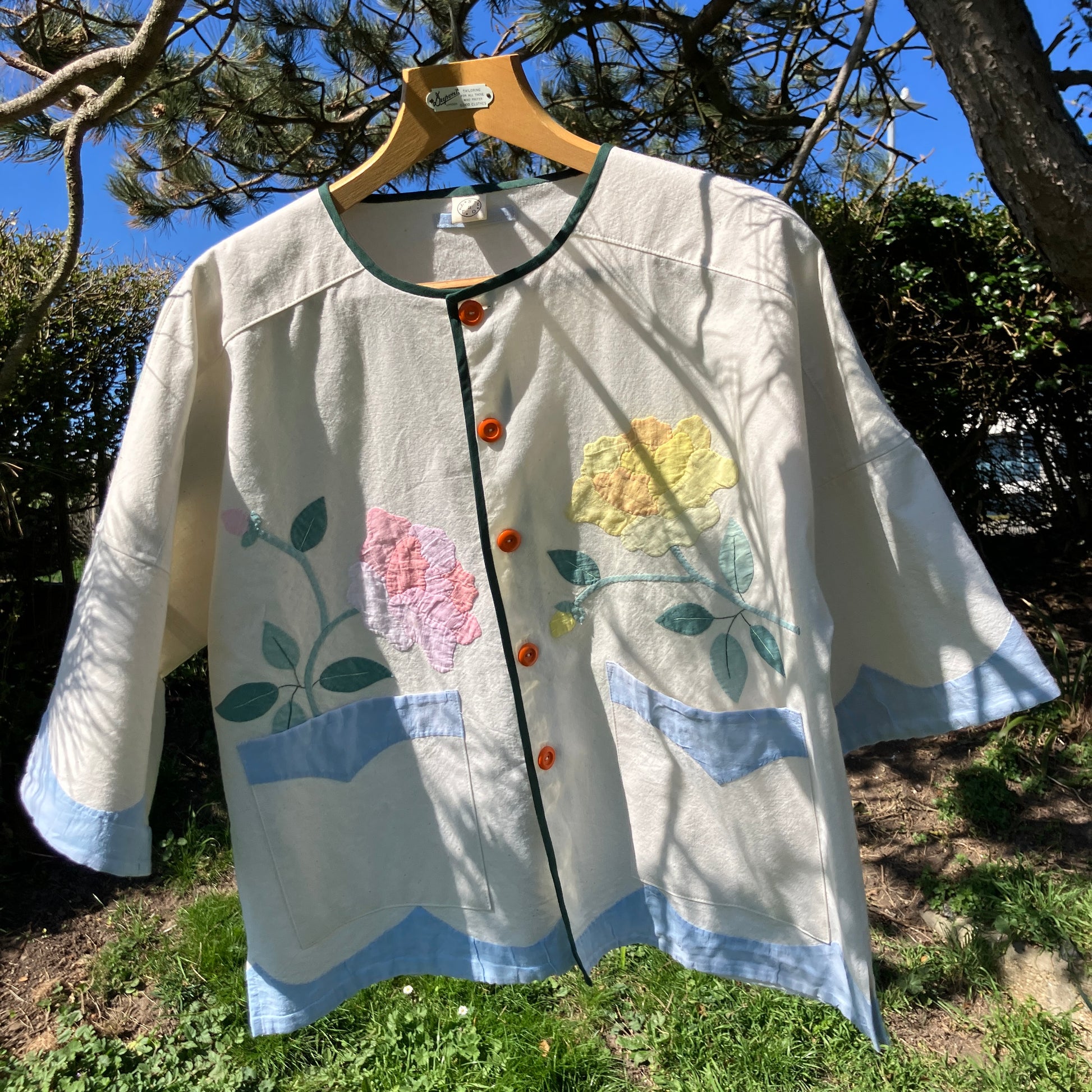 Pretty boxy top with pastel-coloured floral appliqué, made from a vintage cotton bedspread with scalloped edges