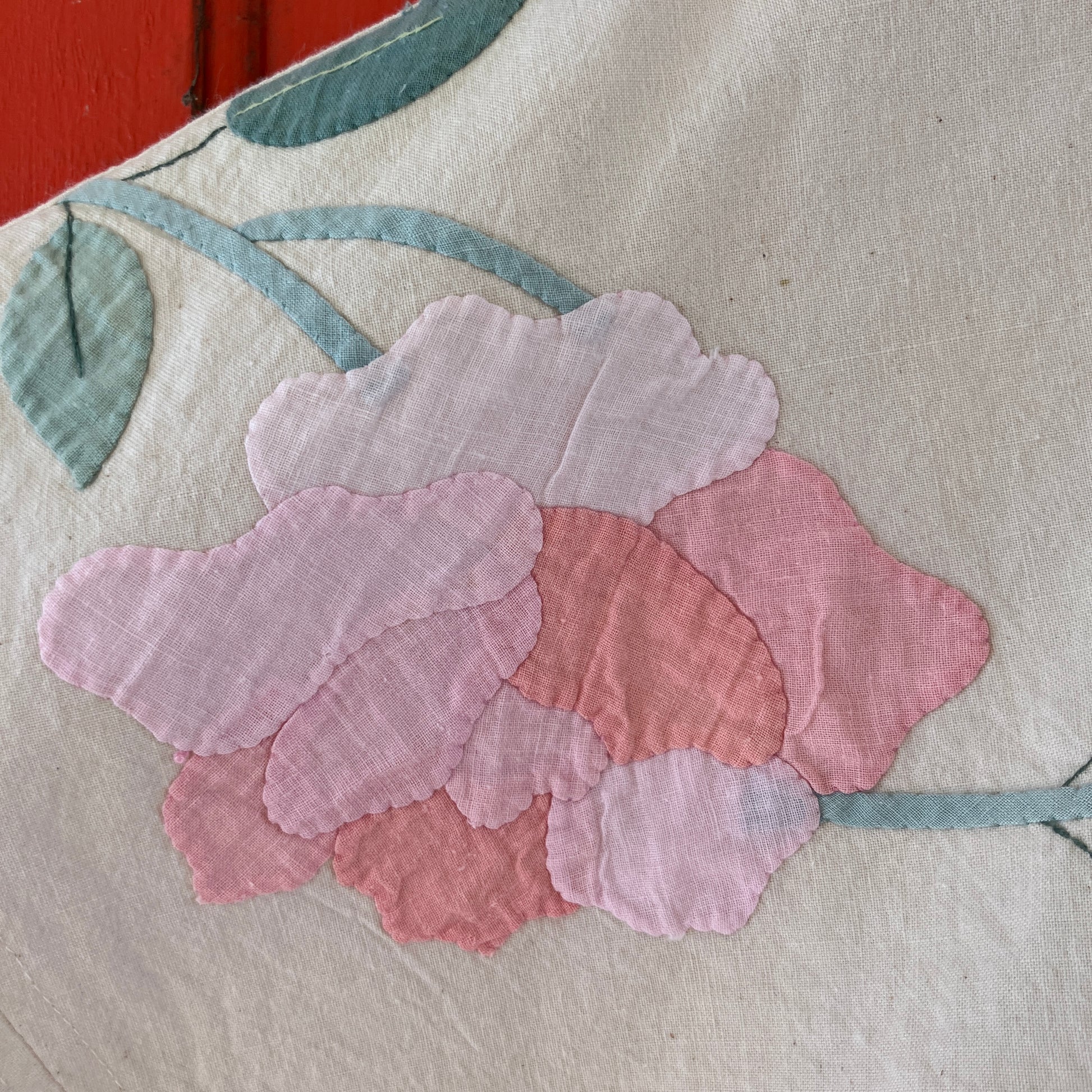 Pretty boxy top with pastel-coloured floral appliqué, made from a vintage cotton bedspread with scalloped edges