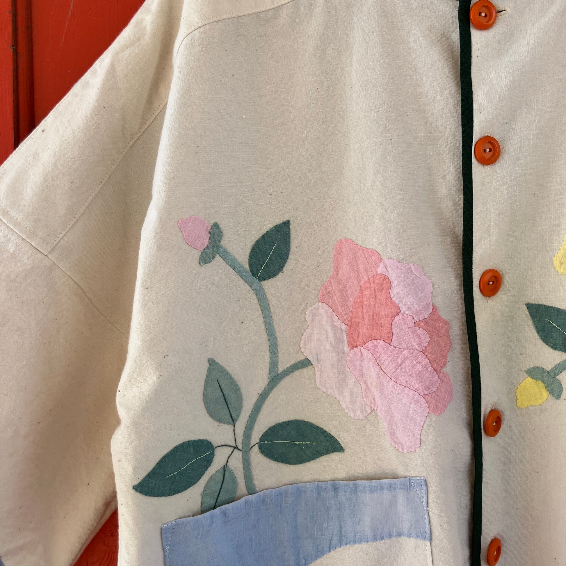 Pretty boxy top with pastel-coloured floral appliqué, made from a vintage cotton bedspread with scalloped edges
