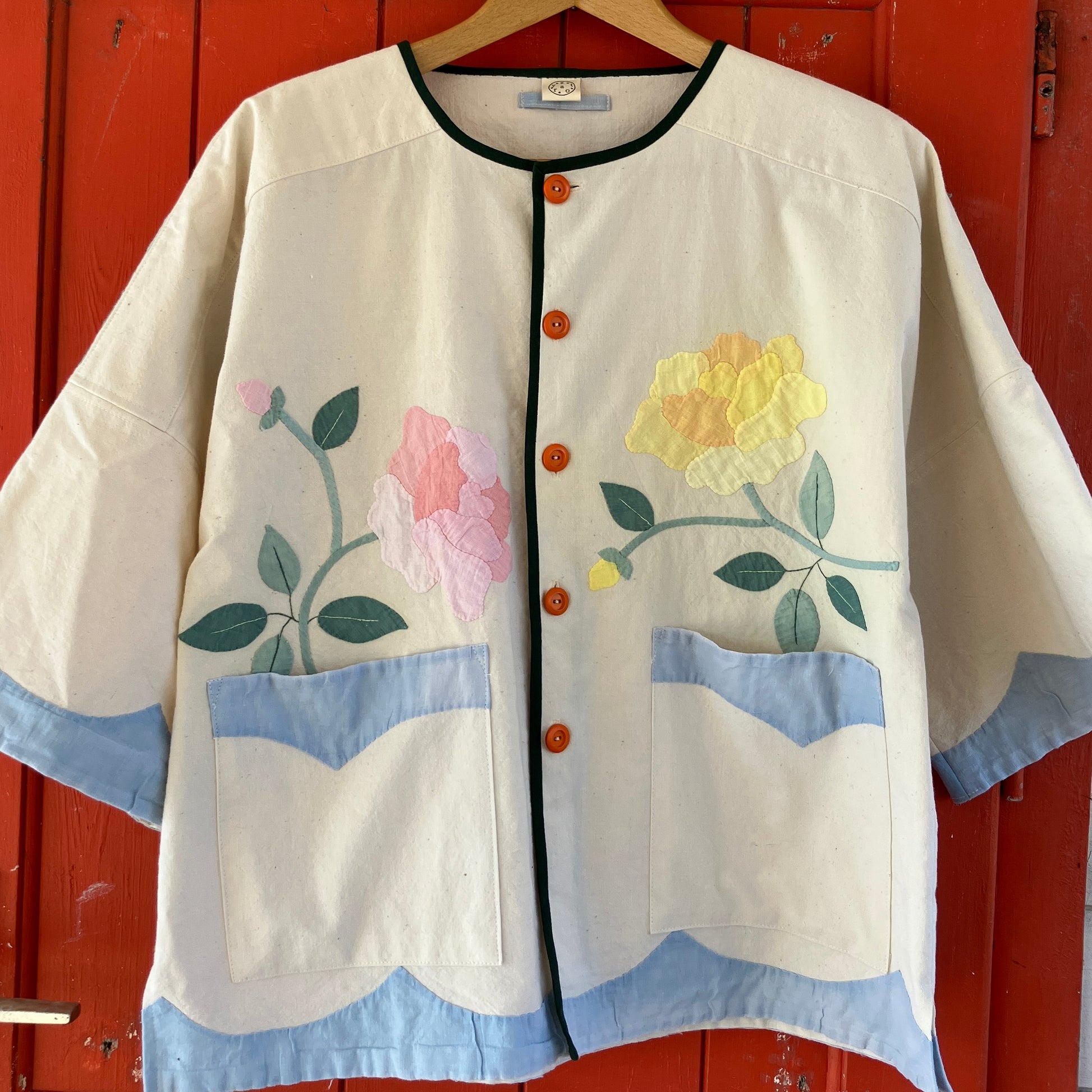 Pretty boxy top with pastel-coloured floral appliqué, made from a vintage cotton bedspread with scalloped edges