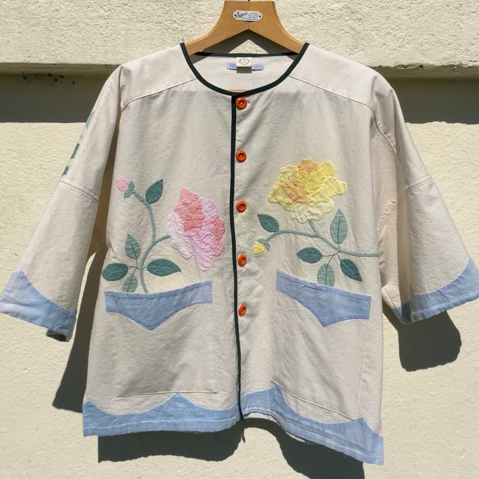 Pretty boxy top with pastel-coloured floral appliqué, made from a vintage cotton bedspread with scalloped edges