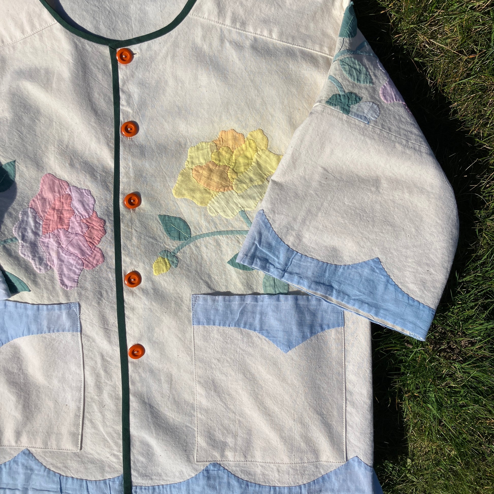 Pretty boxy top with pastel-coloured floral appliqué, made from a vintage cotton bedspread with scalloped edges
