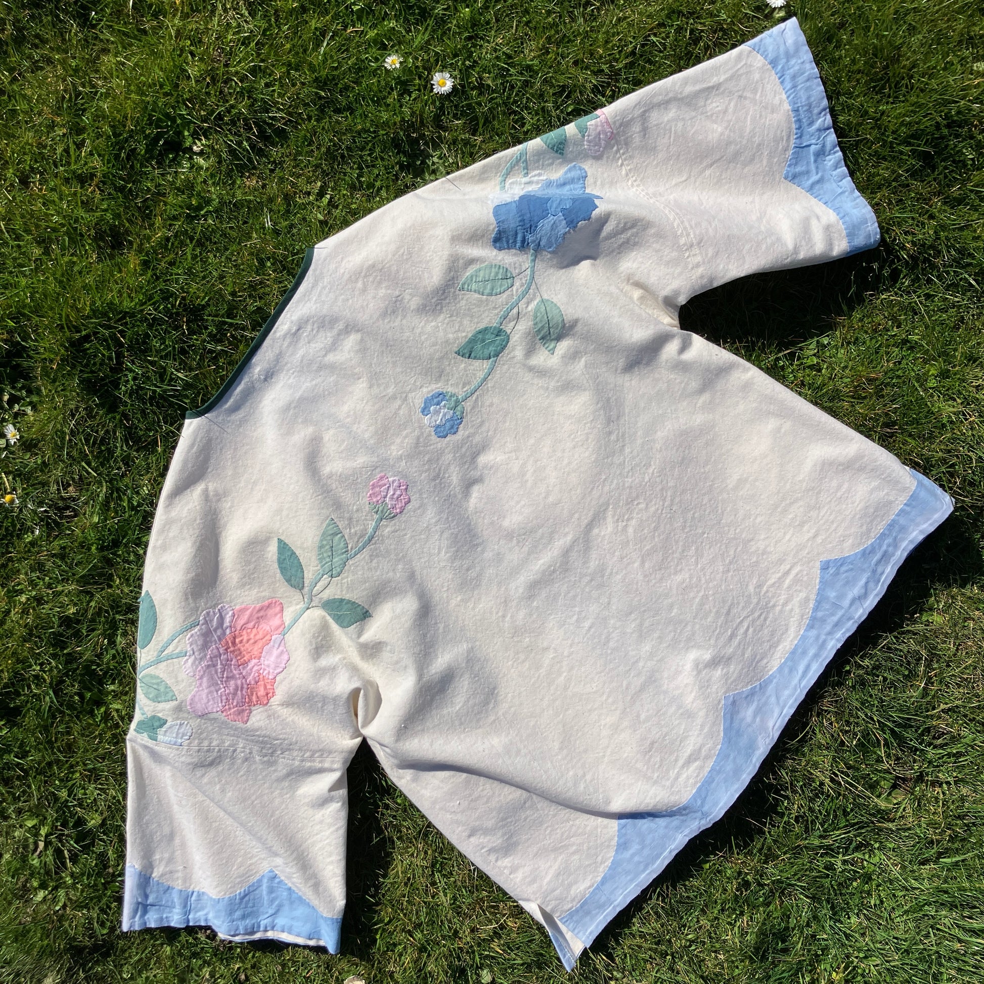 Pretty boxy top with pastel-coloured floral appliqué, made from a vintage cotton bedspread with scalloped edges