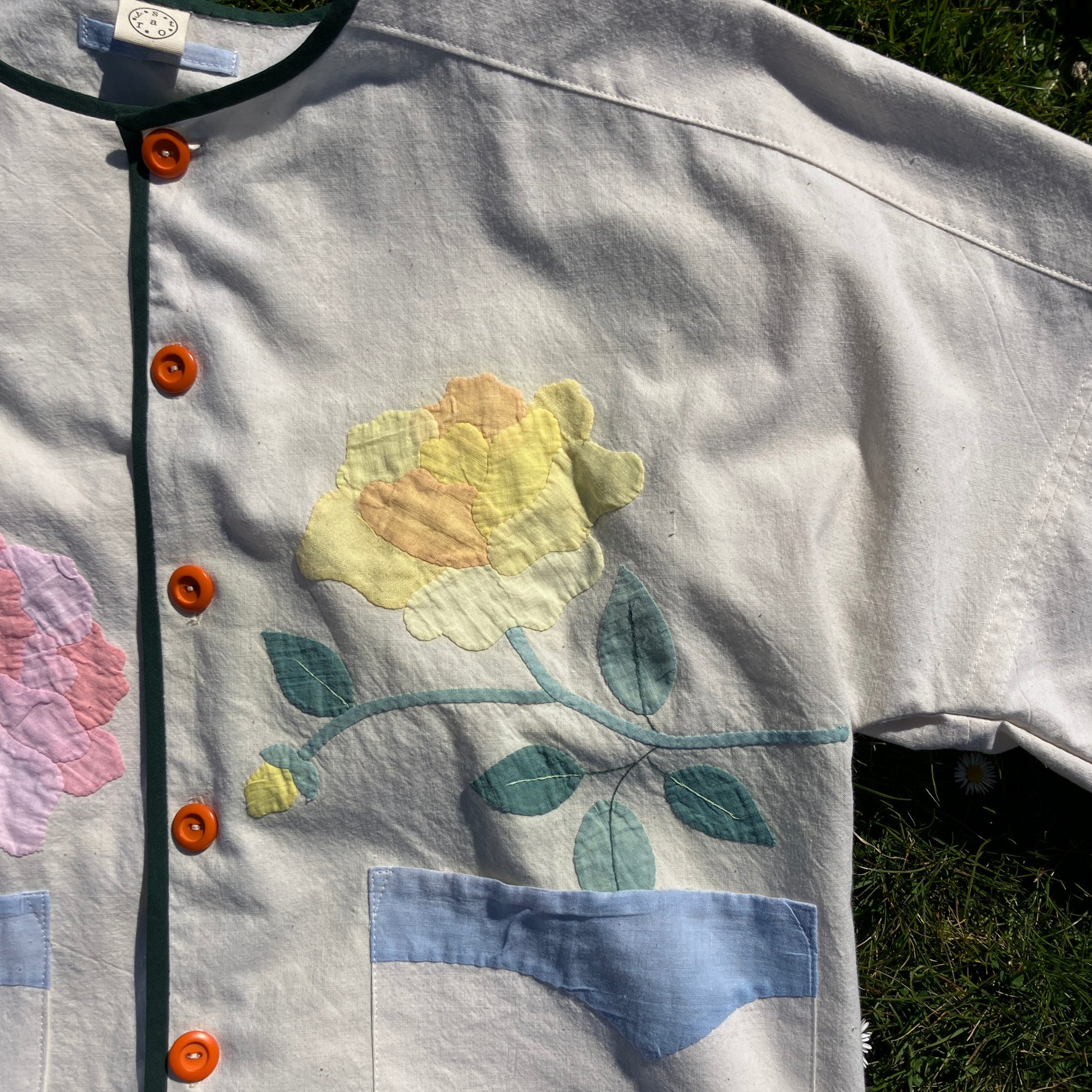 Pretty boxy top with pastel-coloured floral appliqué, made from a vintage cotton bedspread with scalloped edges