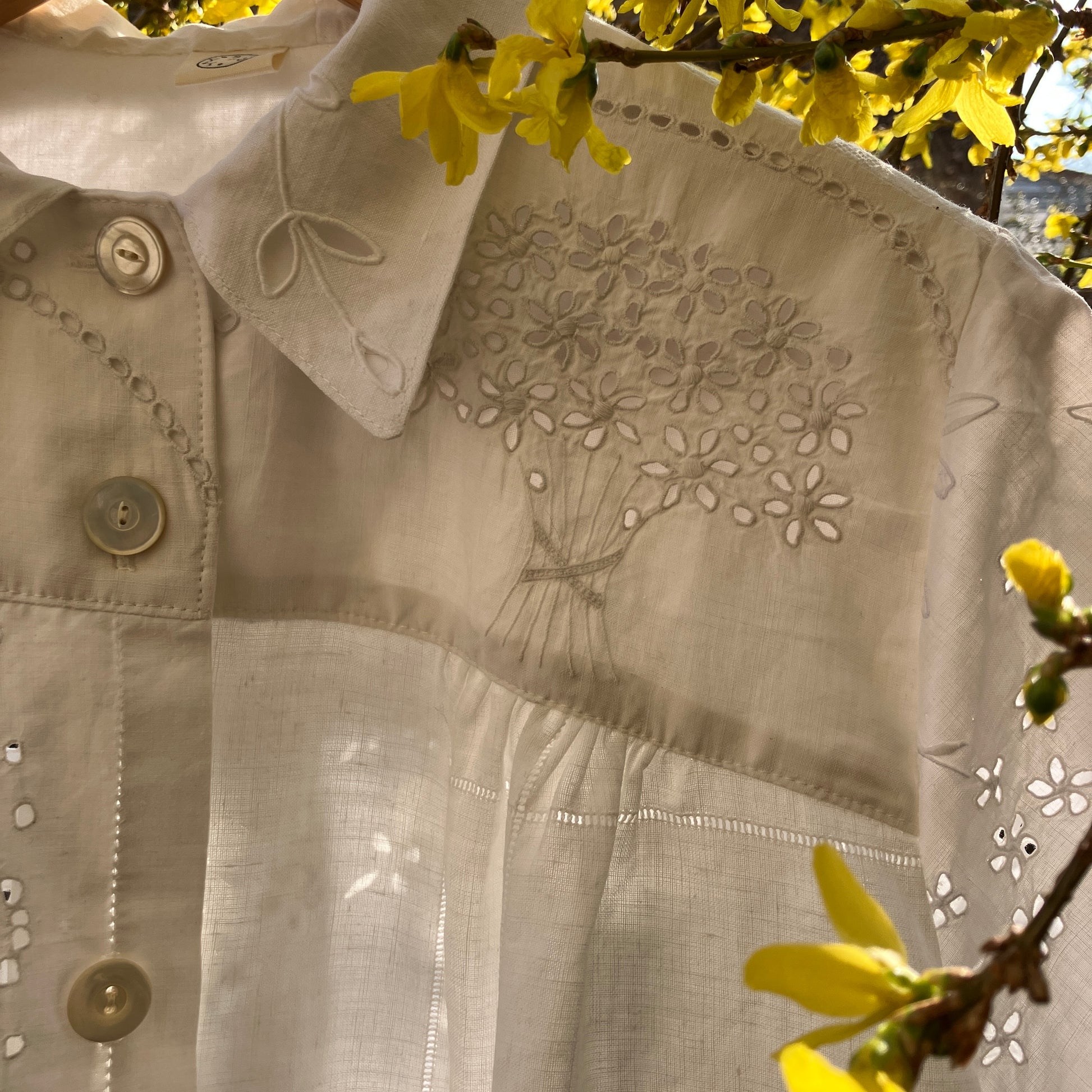 pretty, breezy blouse made from a 
patchwork of reclaimed vintage cotton and linen white cutwork tablecloths.