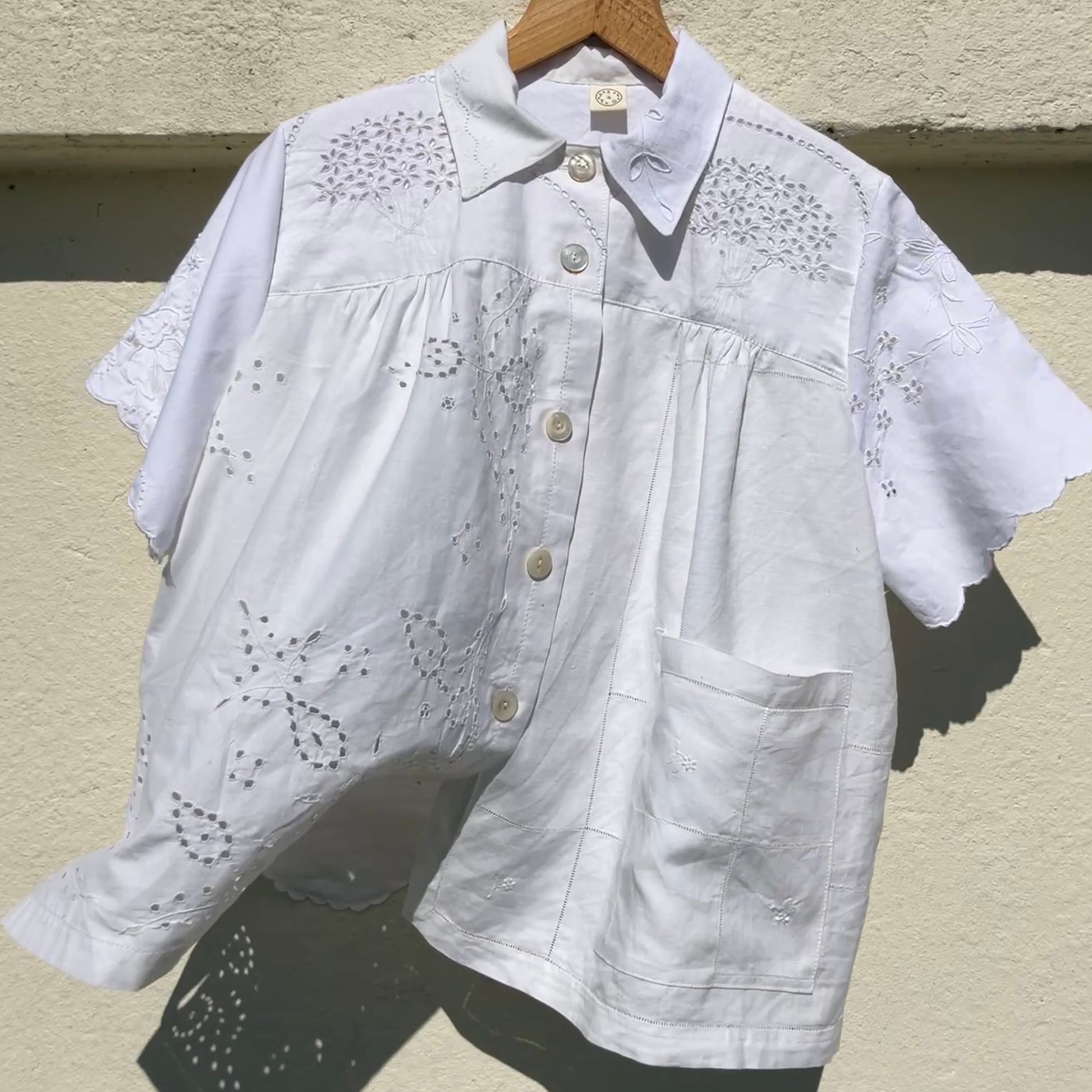 pretty, breezy blouse made from a 
patchwork of reclaimed vintage cotton and linen white cutwork tablecloths.
