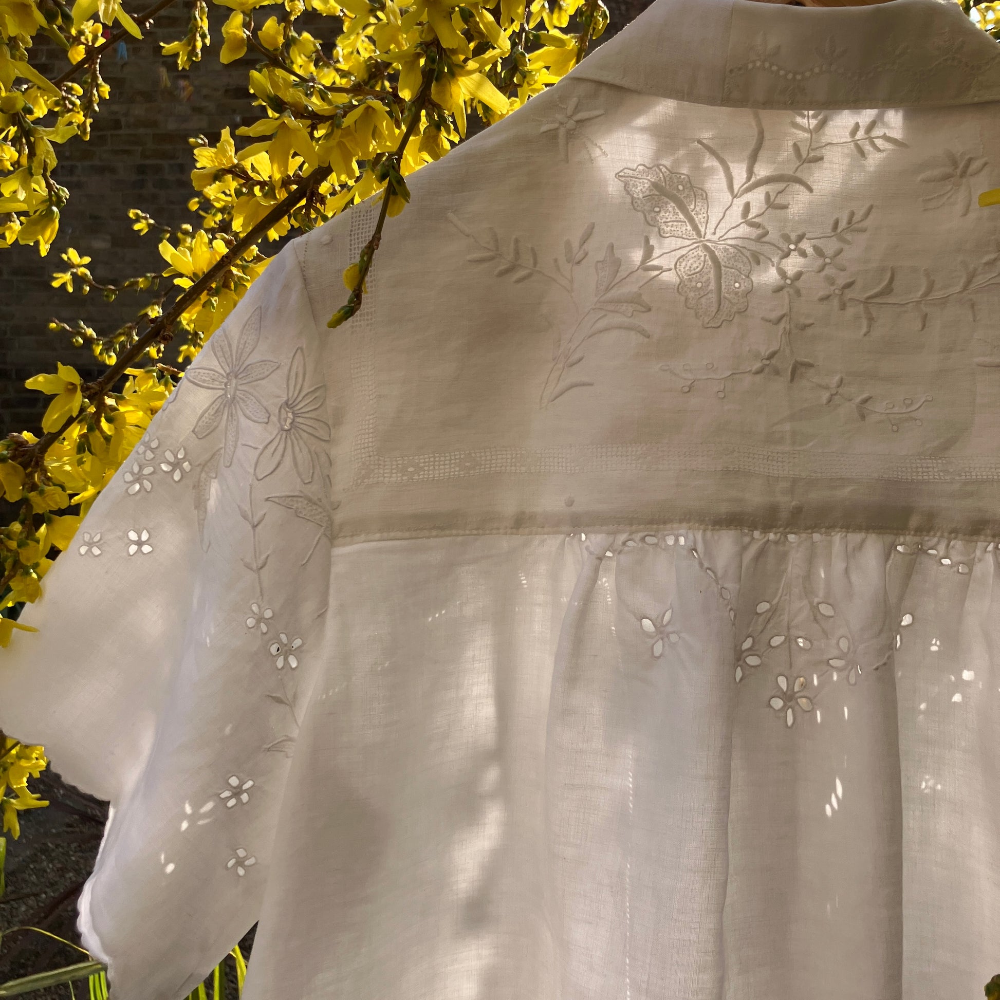 pretty, breezy blouse made from a 
patchwork of reclaimed vintage cotton and linen white cutwork tablecloths.