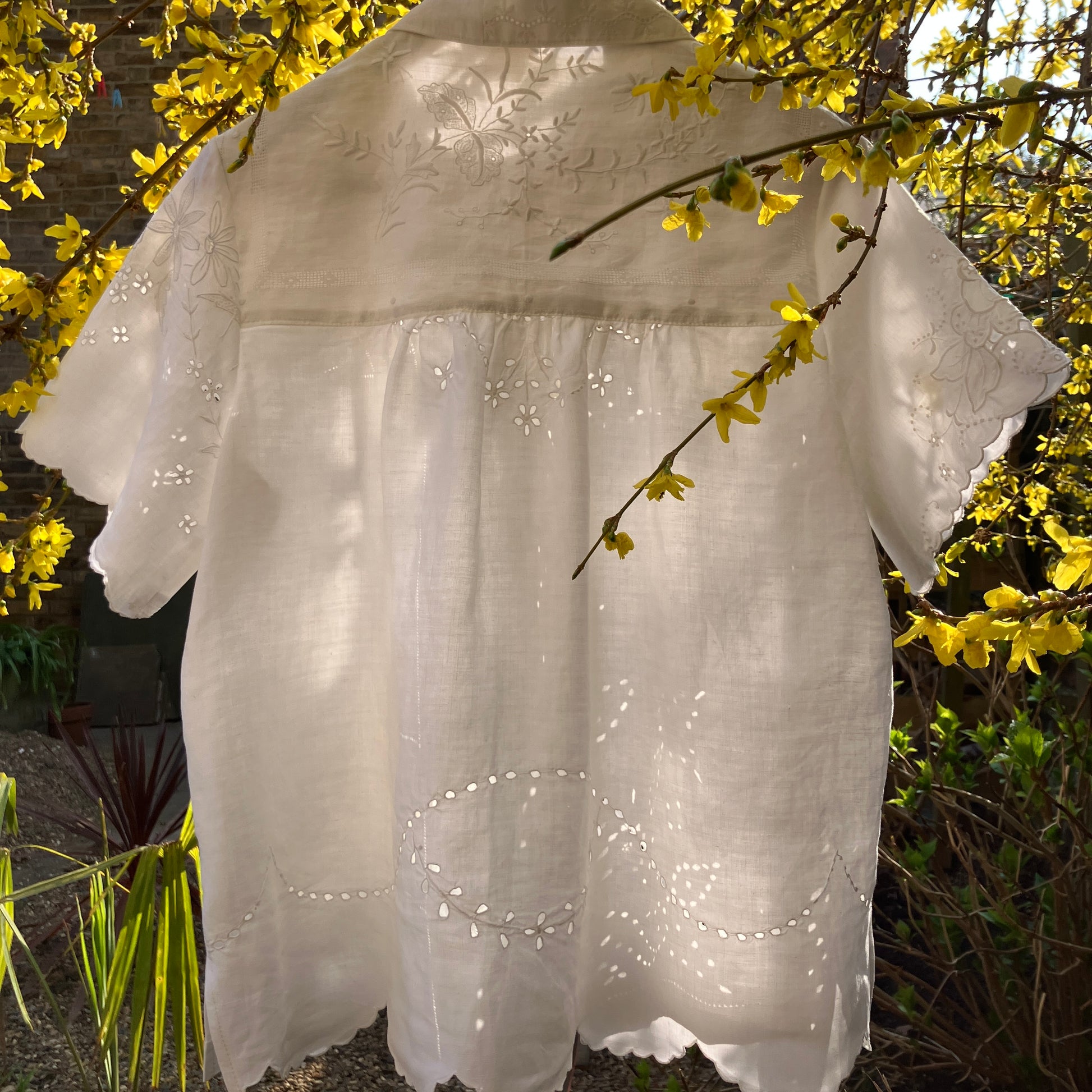 pretty, breezy blouse made from a 
patchwork of reclaimed vintage cotton and linen white cutwork tablecloths.