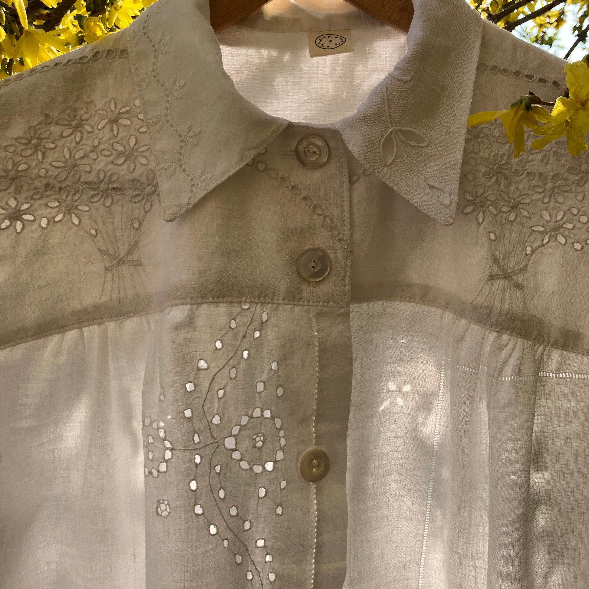 pretty, breezy blouse made from a 
patchwork of reclaimed vintage cotton and linen white cutwork tablecloths.