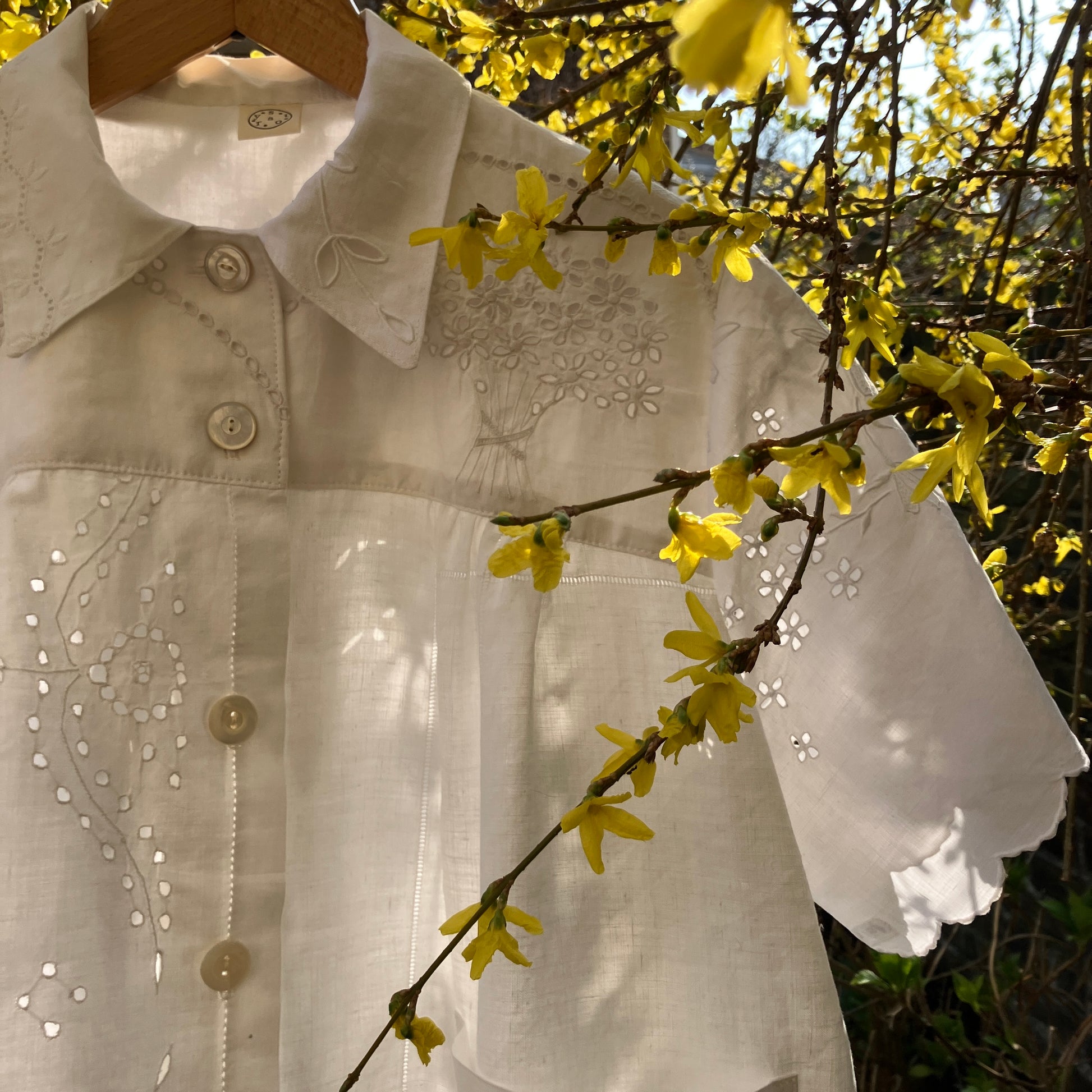 pretty, breezy blouse made from a 
patchwork of reclaimed vintage cotton and linen white cutwork tablecloths.