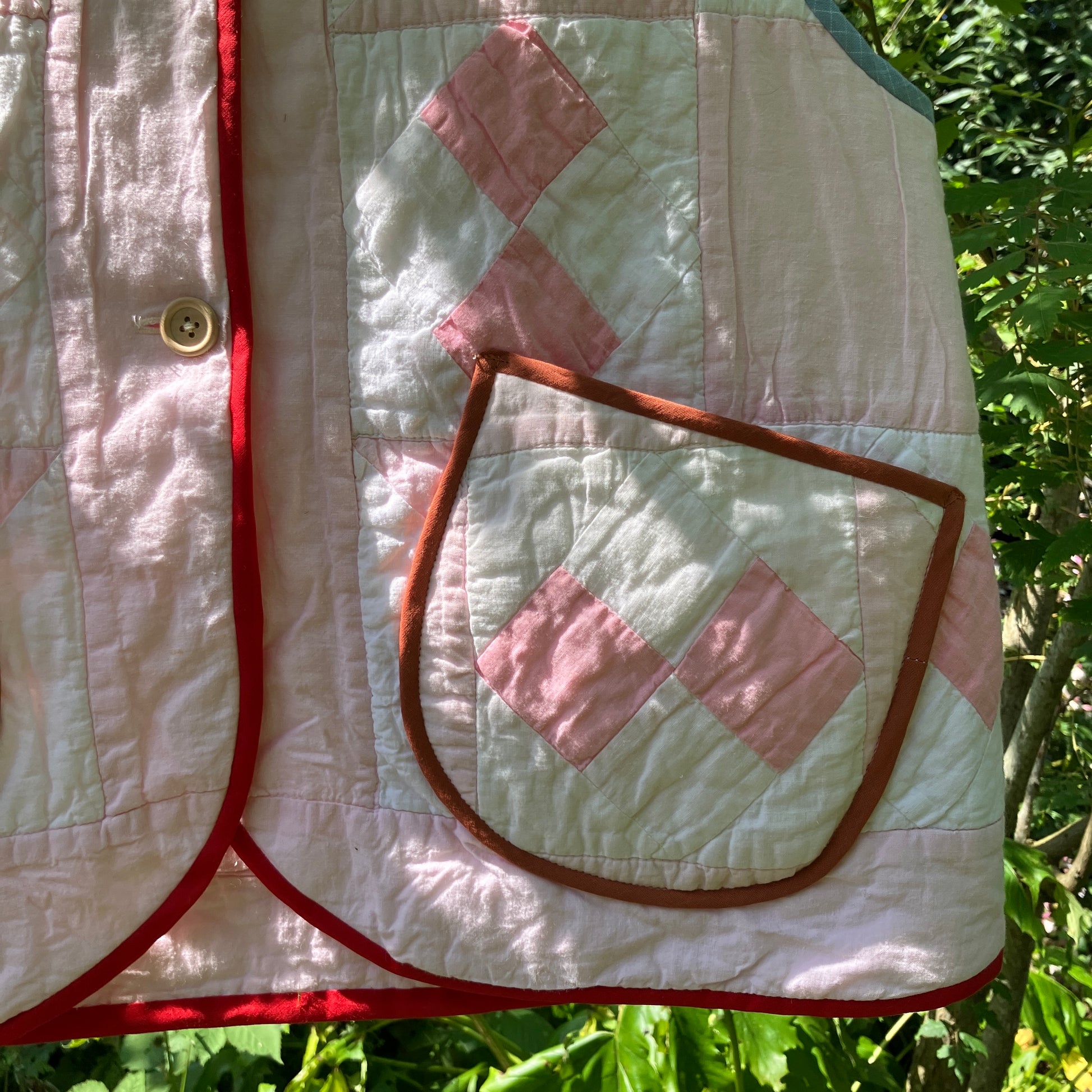 Vest made from a reclaimed pink and white patchwork quilt