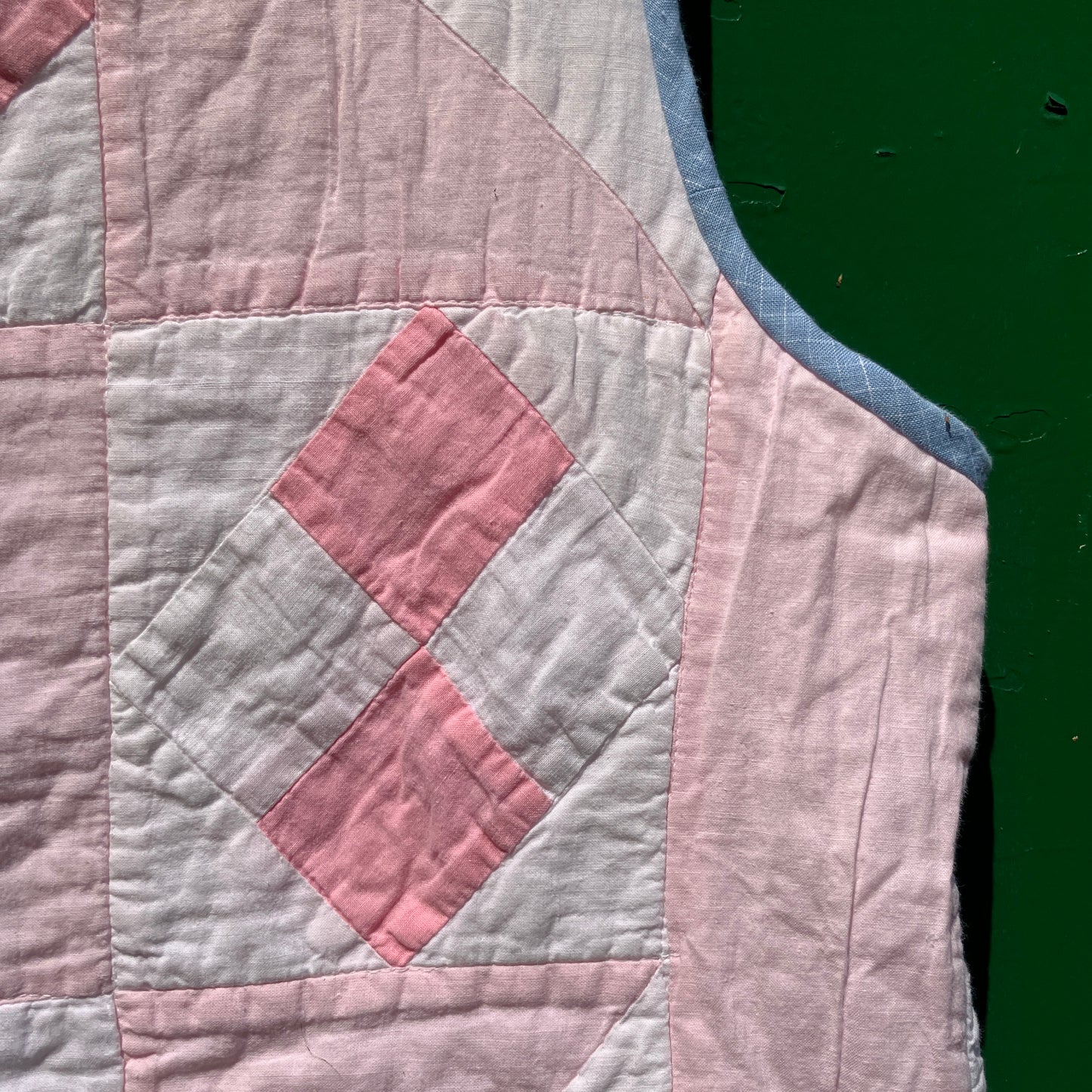 Vest made from a reclaimed pink and white patchwork quilt