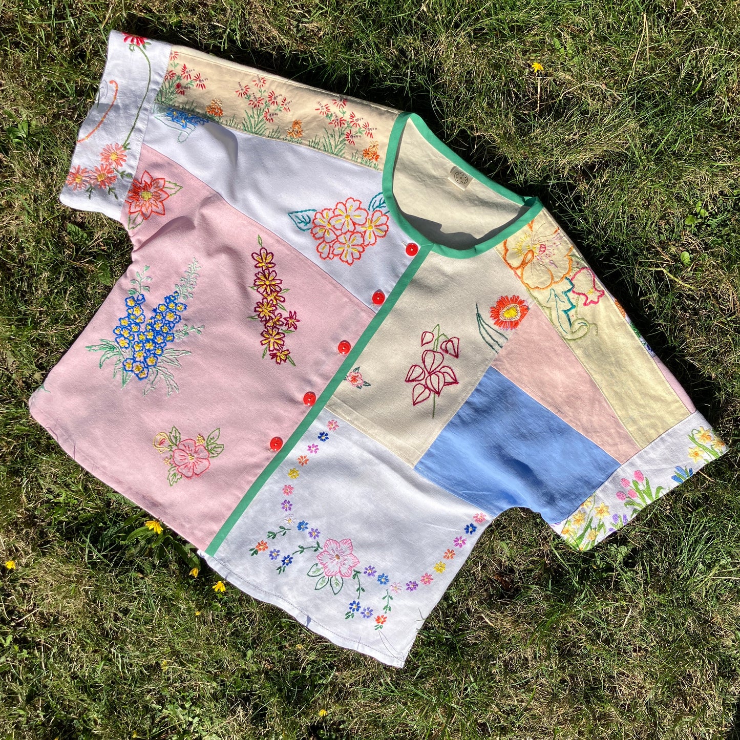 Boxy top made from a patchwork of vintage floral embroidered pastel coloured cotton and linen tablecloths and tray cloths