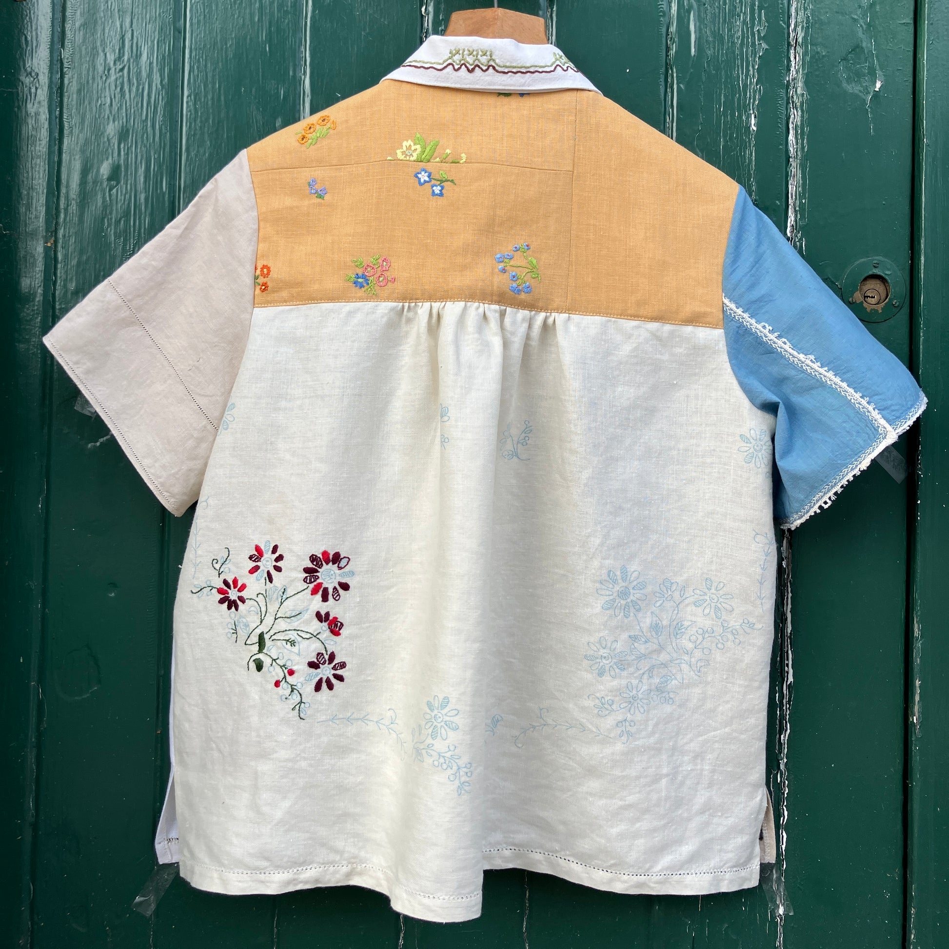 Recycled fabric shirt with embroidery depicting a village pub