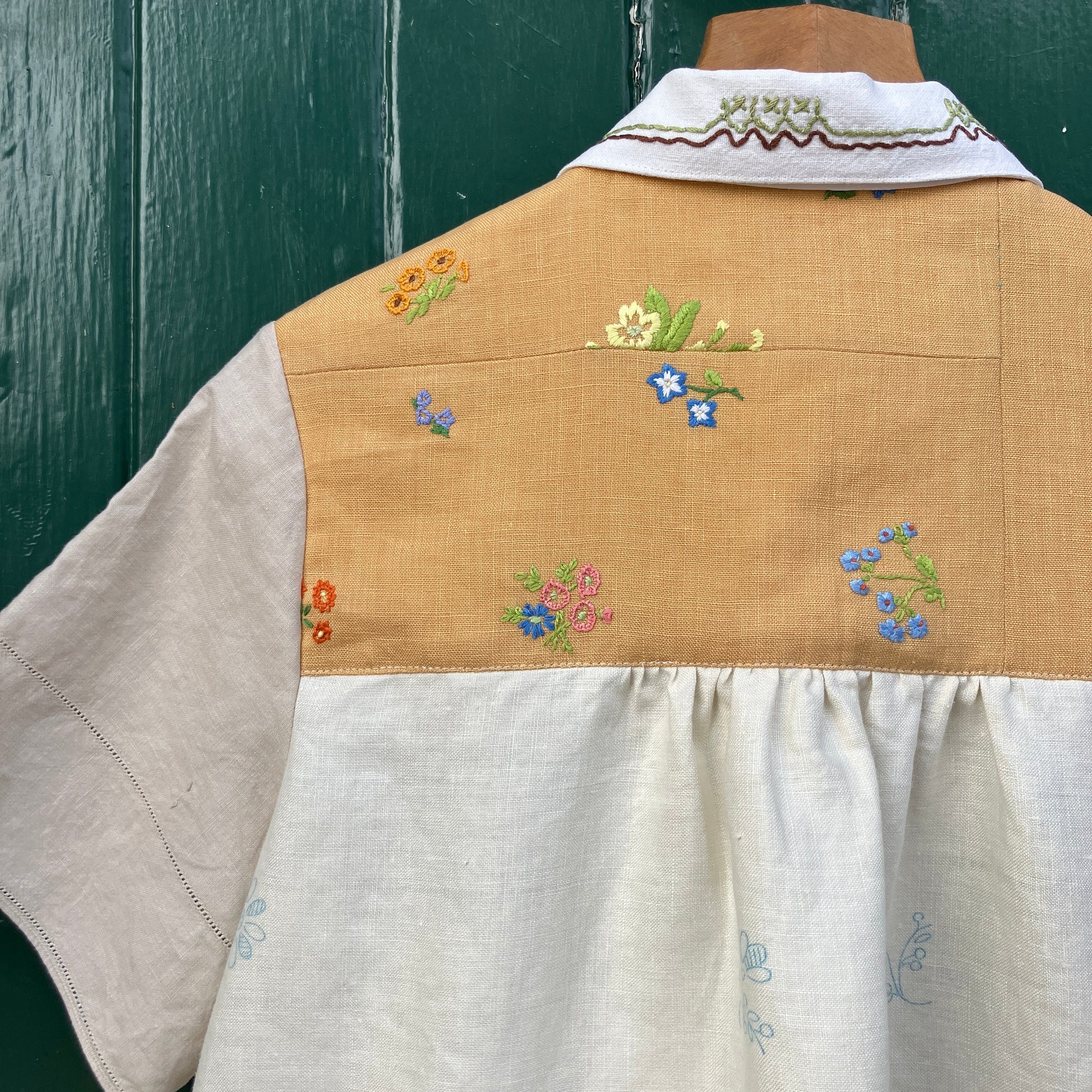 Recycled fabric shirt with embroidery depicting a village pub
