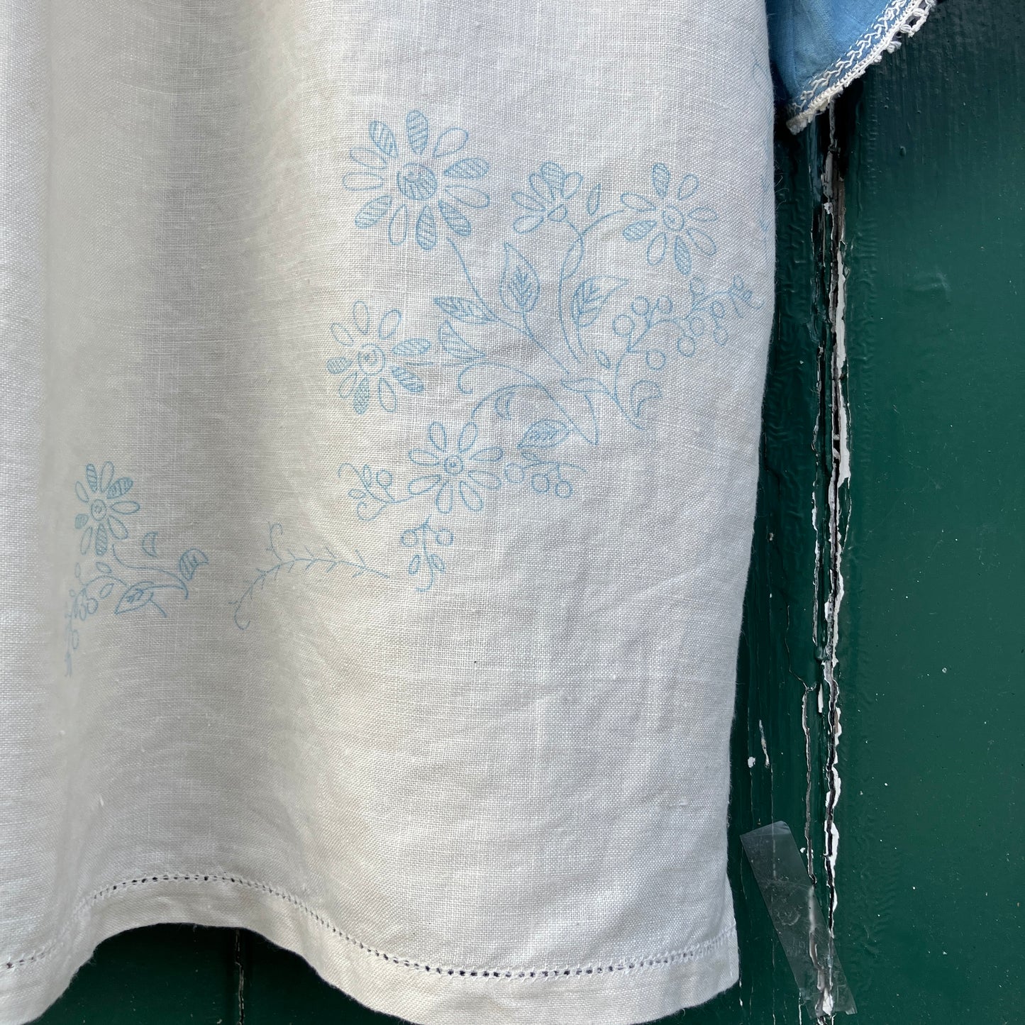Recycled fabric shirt with embroidery depicting a village pub