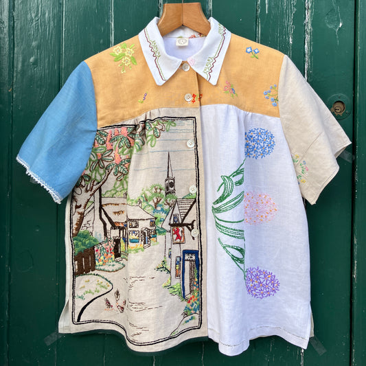 Recycled fabric shirt with embroidery depicting a village pub