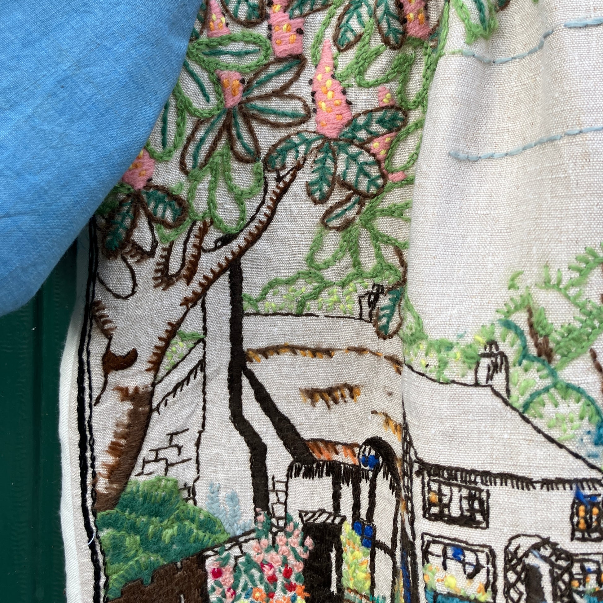 Recycled fabric shirt with embroidery depicting a village pub