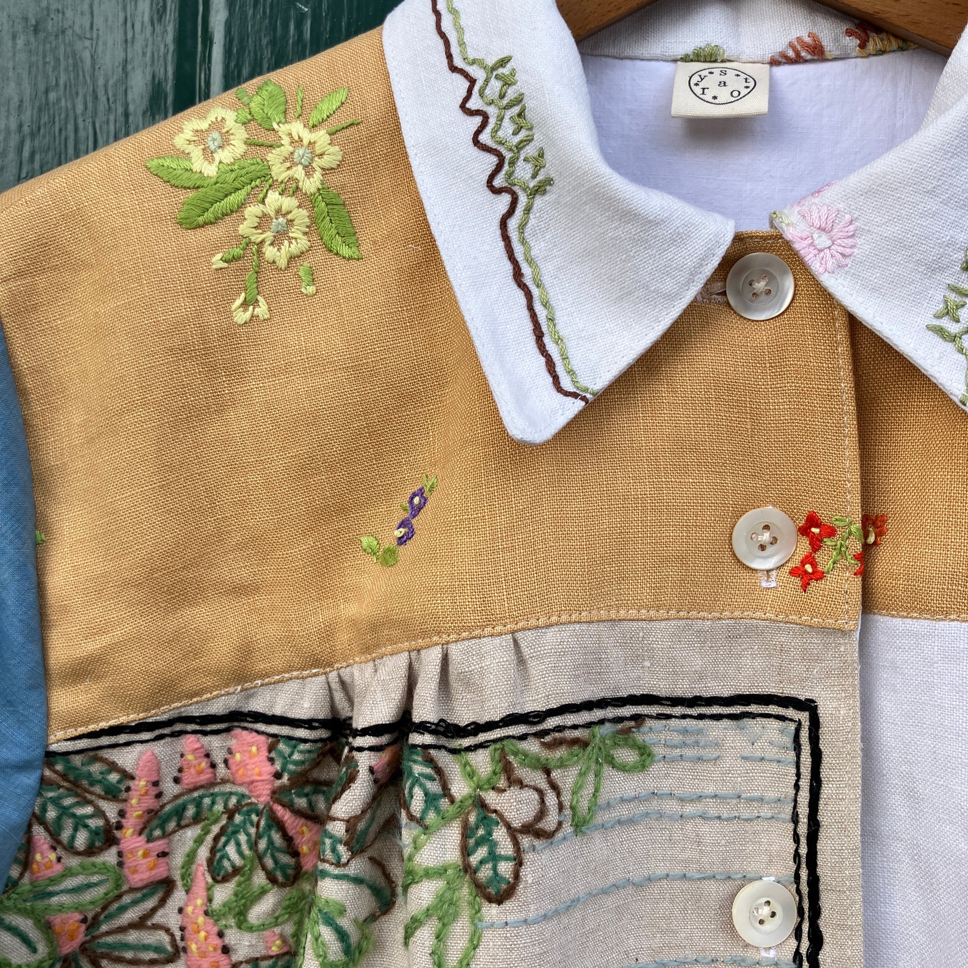 Recycled fabric shirt with embroidery depicting a village pub