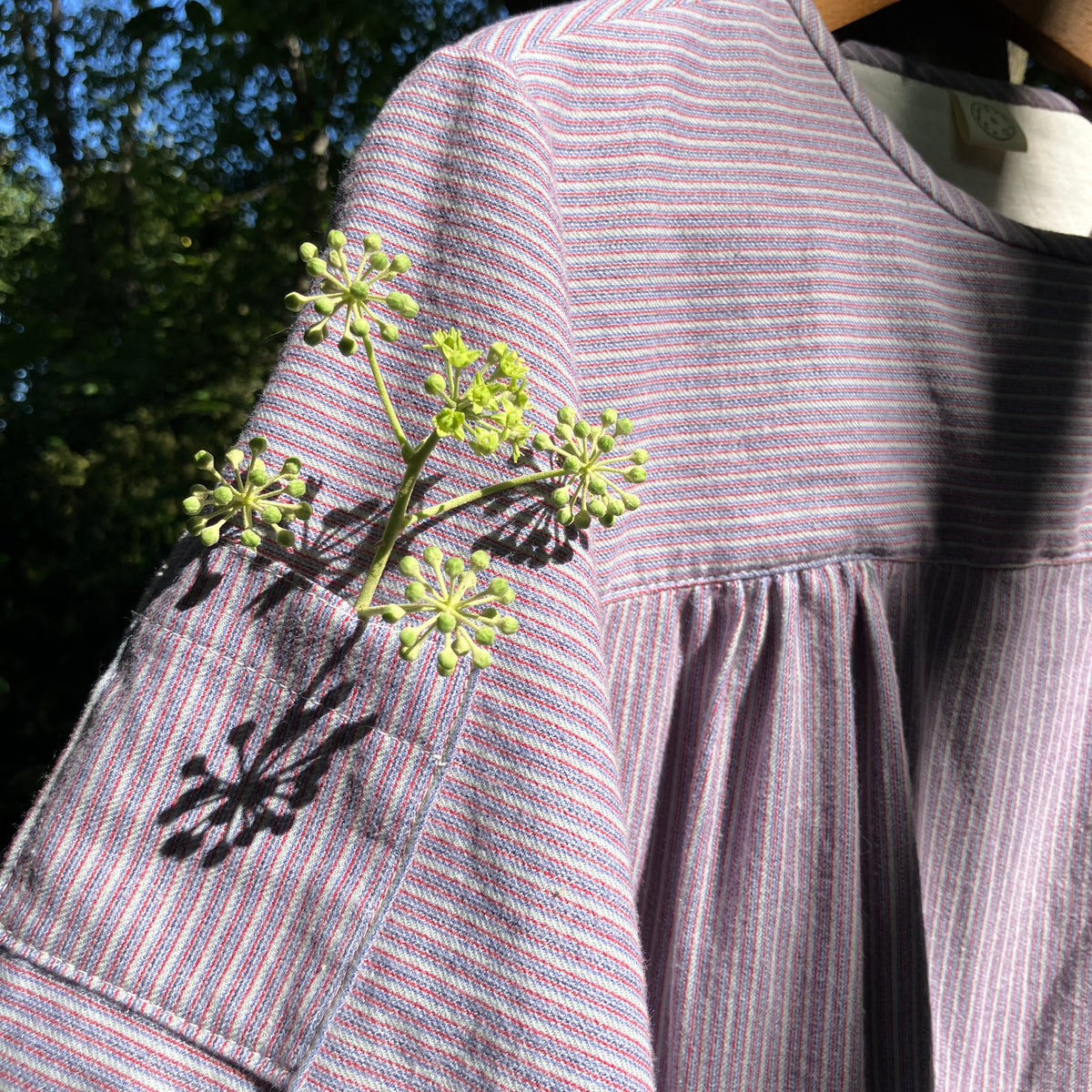 striped smock top with side buttons and three pockets
