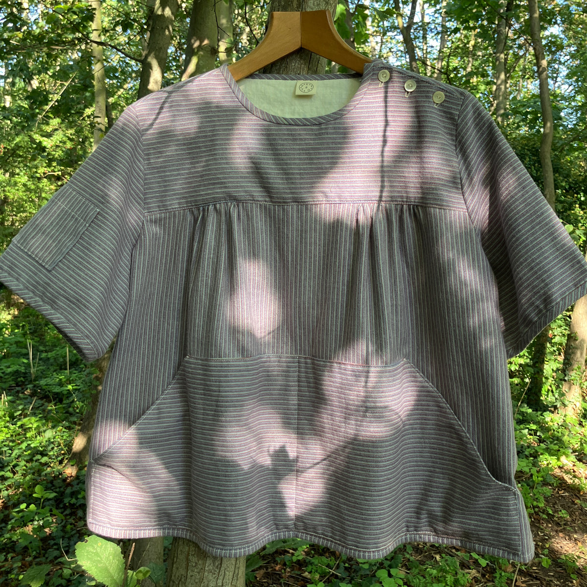 striped smock top with side buttons and three pockets