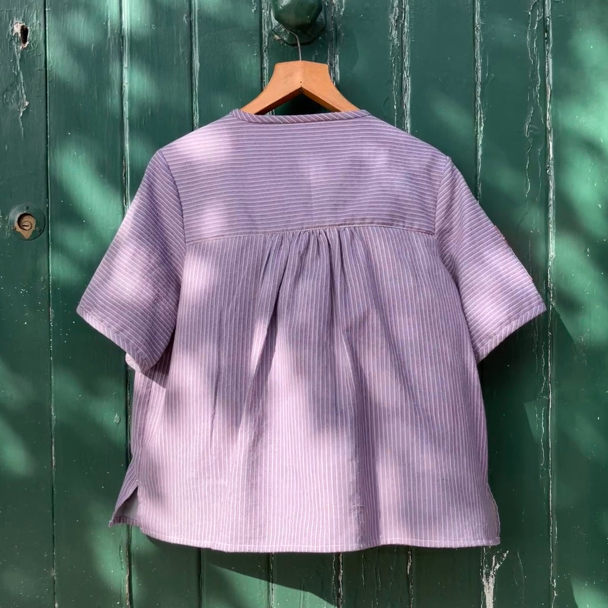 striped smock top with side buttons and three pockets