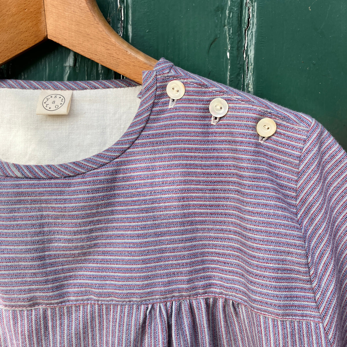 striped smock top with side buttons and three pockets