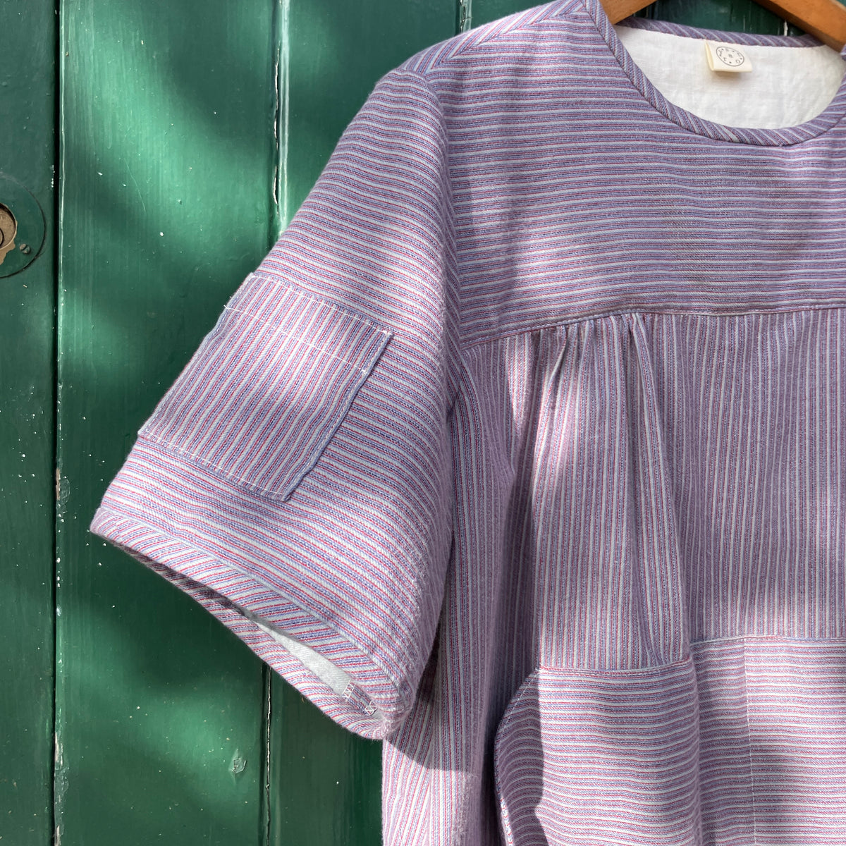 striped smock top with side buttons and three pockets
